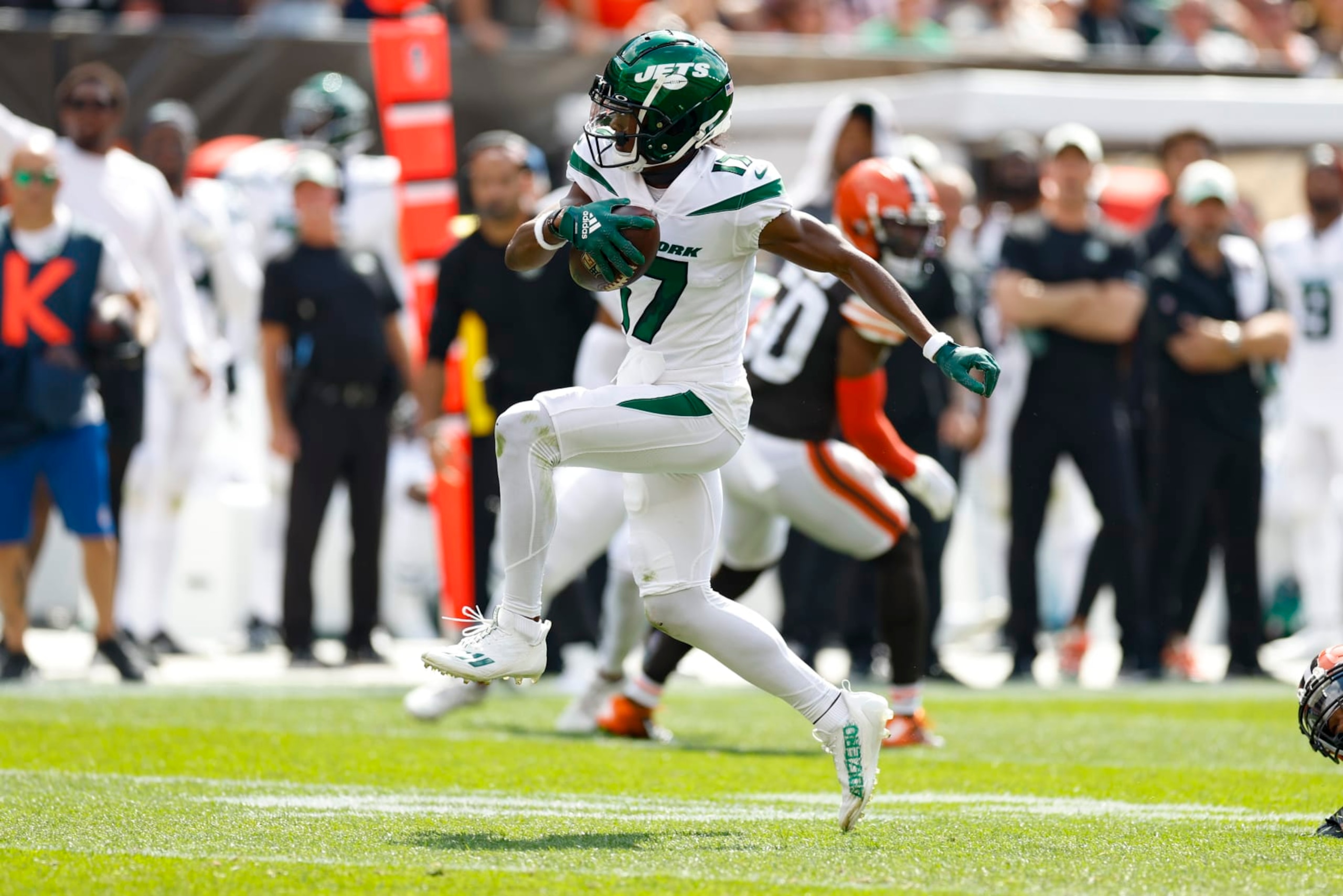New York Jets wide receiver Garrett Wilson (17) takes off after he escapes the grasp of New York Jets running back Breece Hall (20) after making a catch during the first half of an NFL football game, Sunday, Sept. 18, 2022, in Cleveland. (AP Photo/Ron Schwane)