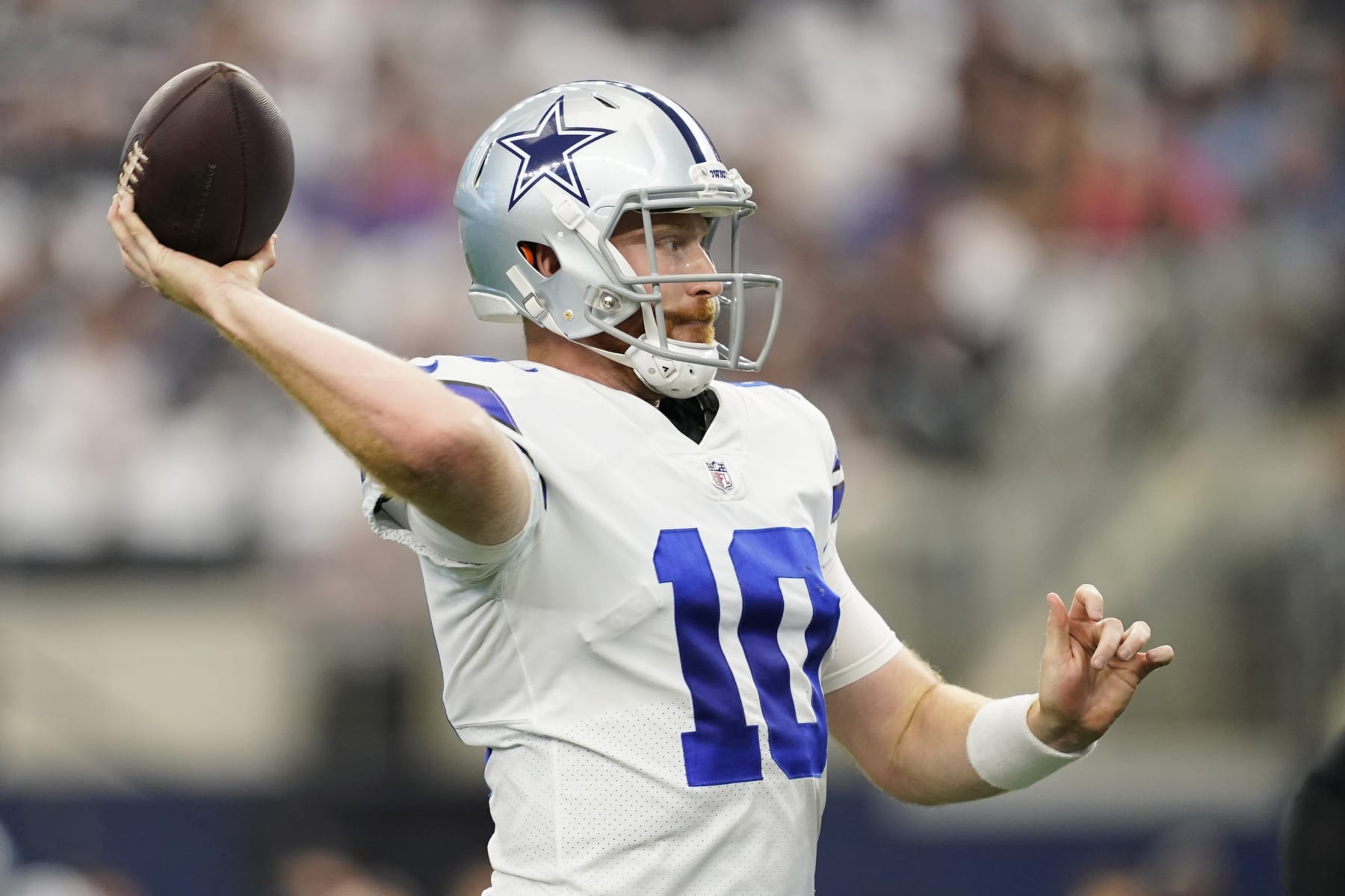 Dallas Cowboys quarterback Cooper Rush (10) tosses a touchdown pass during the first half of an NFL football game Sunday, Sept. 18, 2022, in Arlington, Tx. (AP Photo/Tony Gutierrez)