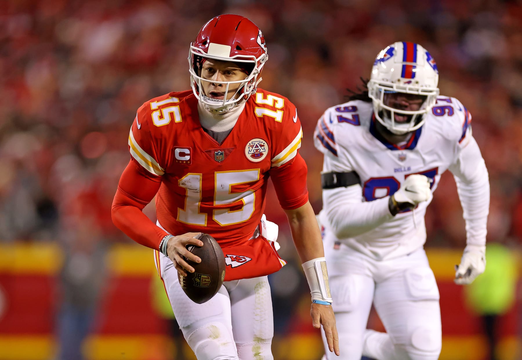 KANSAS CITY, MISSOURI - JANUARY 23: Patrick Mahomes #15 of the Kansas City Chiefs runs the ball for an 8 yard touchdown against the Buffalo Bills during the first quarter in the AFC Divisional Playoff game at Arrowhead Stadium on January 23, 2022 in Kansas City, Missouri. (Photo by David Eulitt/Getty Images)