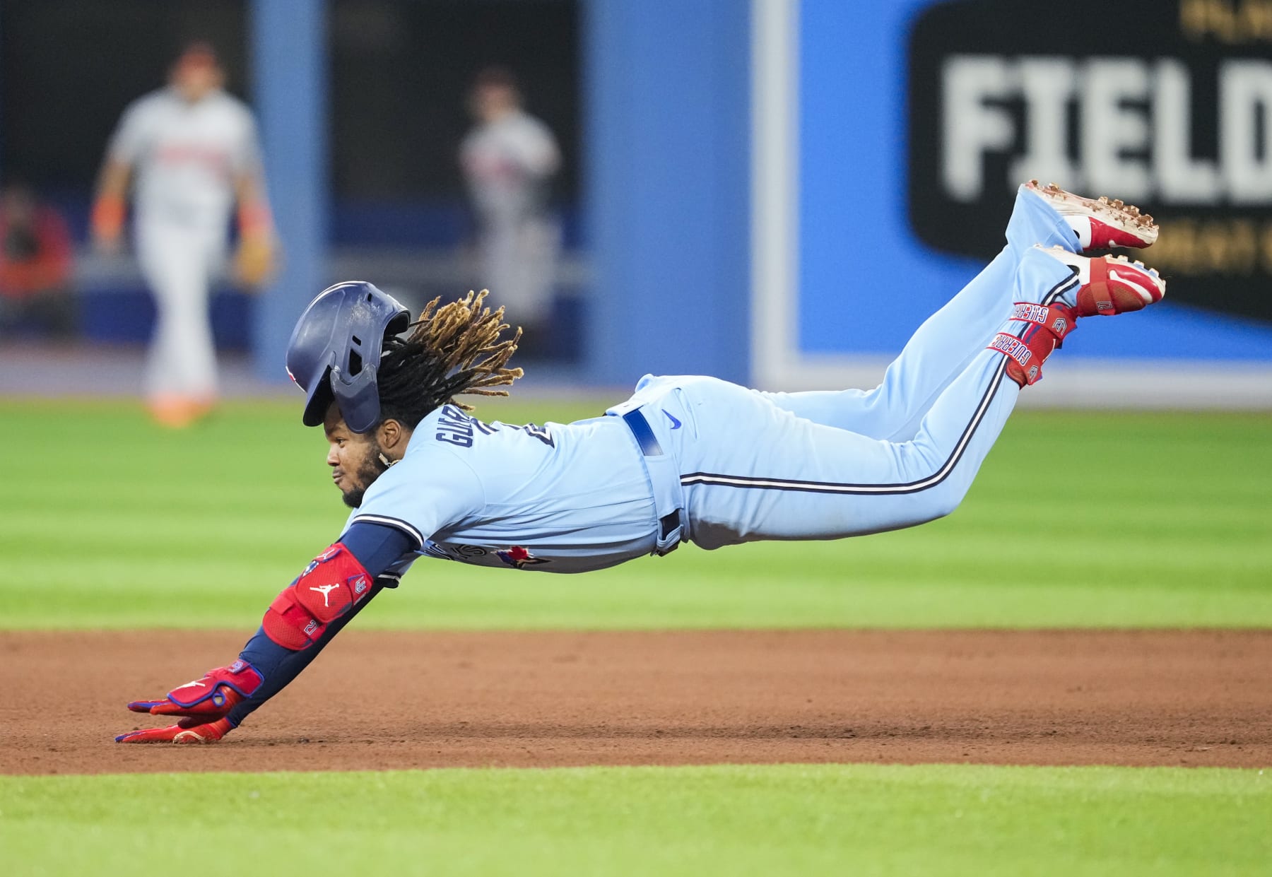 TORONTO, ON - SEPTEMBER 18: Vladimir Guerrero Jr. #27 of the Toronto Blue Jays dives into second base with a double against the Baltimore Orioles in the fifth inning at the Rogers Centre on September 18, 2022 in Toronto, Ontario, Canada. (Photo by Mark Blinch/Getty Images)