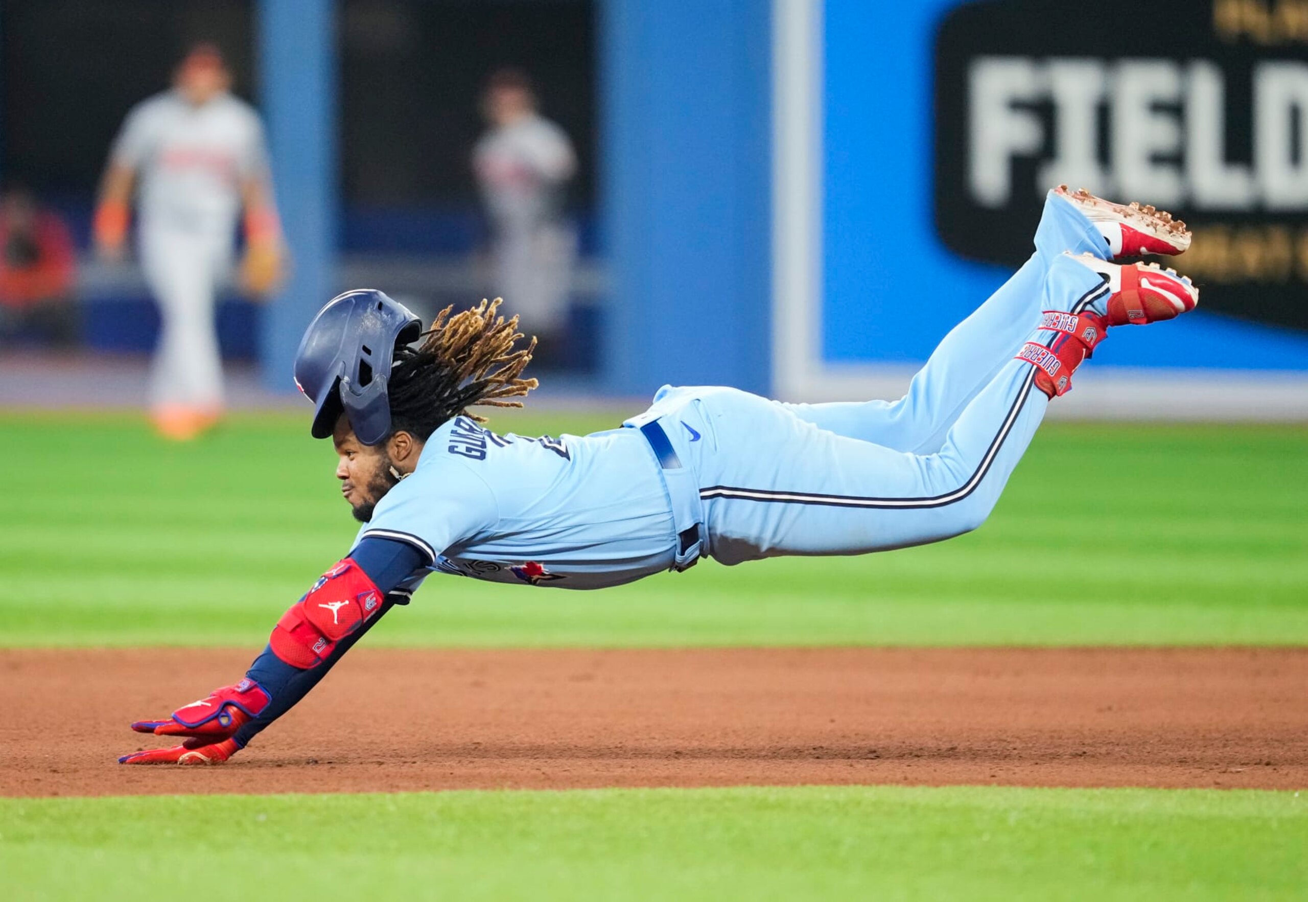 TORONTO, ON - SEPTEMBER 18: Vladimir Guerrero Jr. #27 of the Toronto Blue Jays dives into second base with a double against the Baltimore Orioles in the fifth inning at the Rogers Centre on September 18, 2022 in Toronto, Ontario, Canada. (Photo by Mark Blinch/Getty Images)