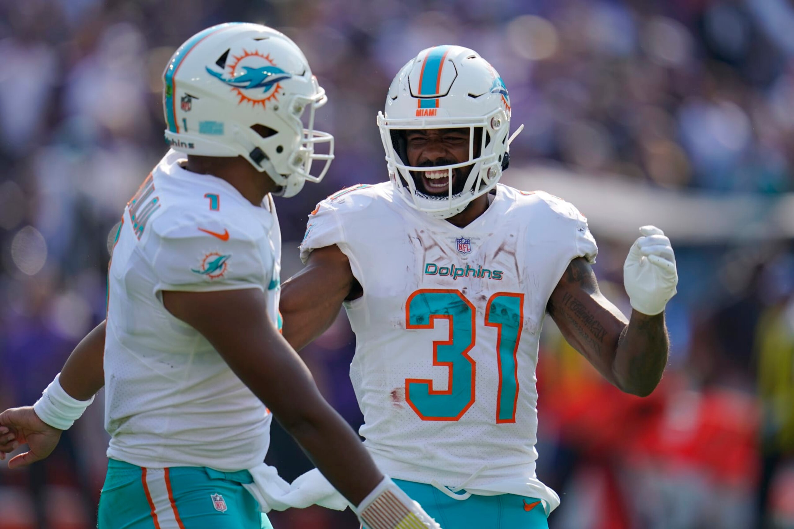 Miami Dolphins running back Raheem Mostert (31) and quarterback Tua Tagovailoa (1) celebrate a touchdown during the second half of an NFL football game against the Baltimore Ravens, Sunday, Sept. 18, 2022, in Baltimore. (AP Photo/Julio Cortez) Miami Dolphins running back Raheem Mostert (31) and quarterback Tua Tagovailoa (1) celebrate a touchdown during the second half of an NFL football game against the Baltimore Ravens, Sunday, Sept. 18, 2022, in Baltimore. (AP Photo/Julio Cortez)