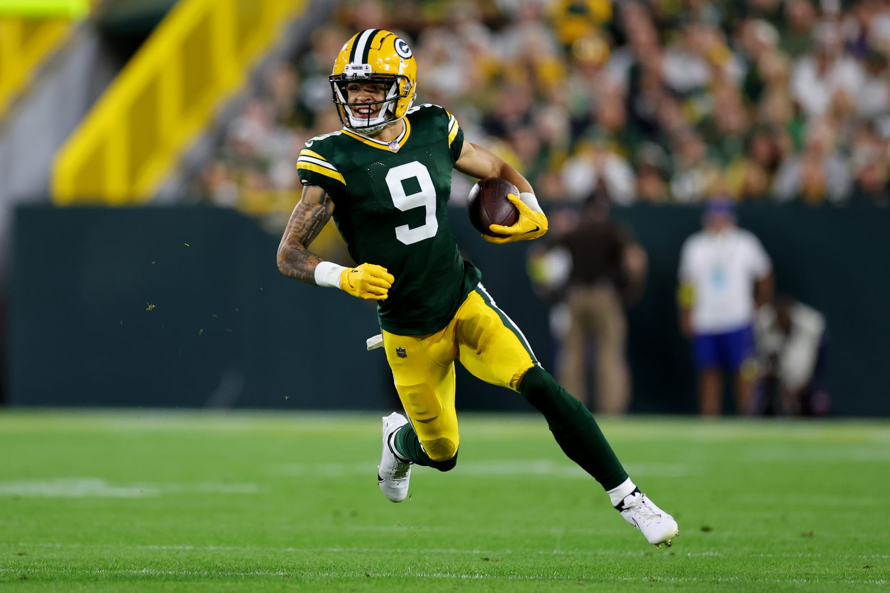 GREEN BAY, WISCONSIN - SEPTEMBER 18: Christian Watson #9 of the Green Bay Packers runs with the ball during the first quarter in the game against the Chicago Bears at Lambeau Field on September 18, 2022 in Green Bay, Wisconsin. (Photo by Michael Reaves/Getty Images)