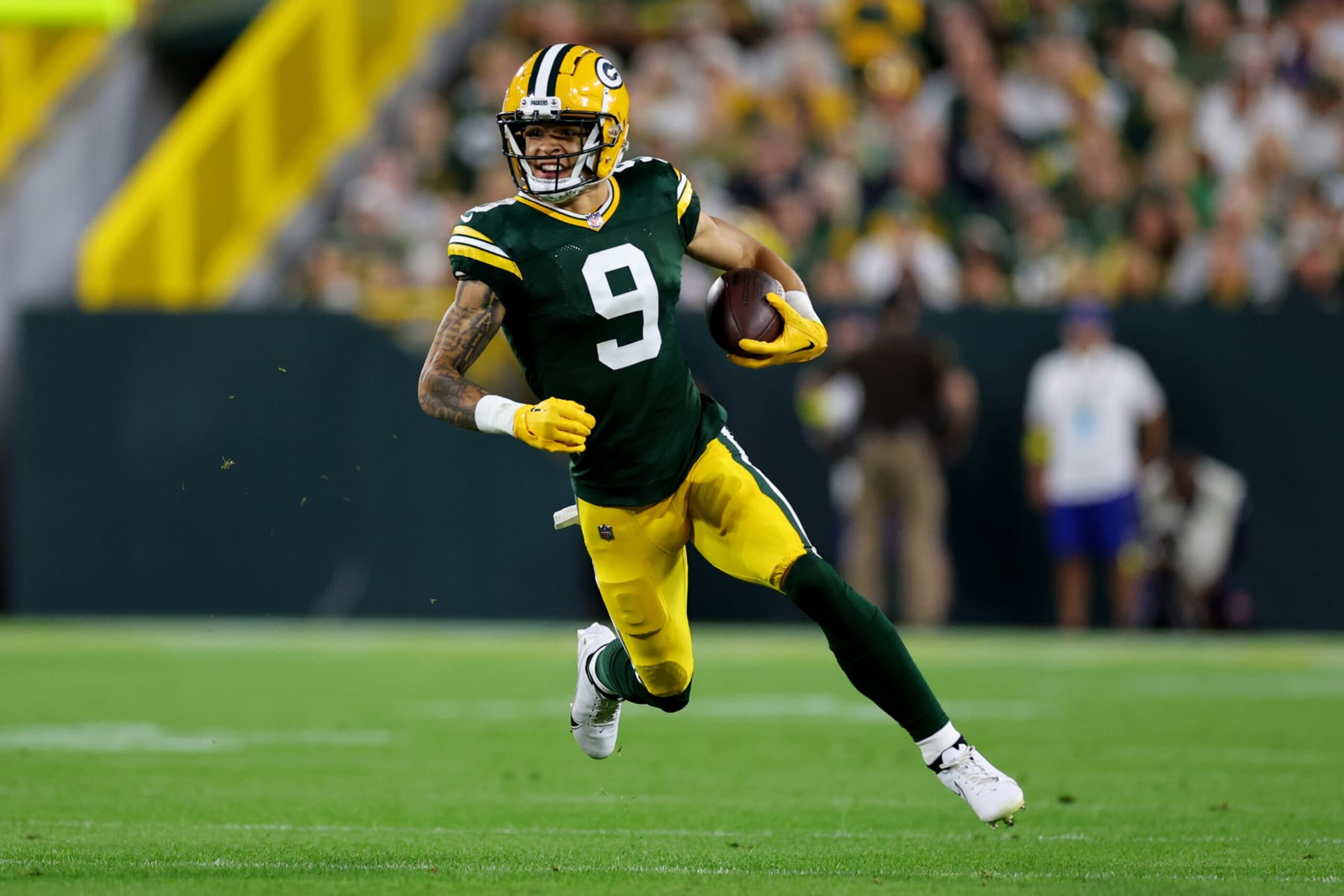 GREEN BAY, WISCONSIN - SEPTEMBER 18: Christian Watson #9 of the Green Bay Packers runs with the ball during the first quarter in the game against the Chicago Bears at Lambeau Field on September 18, 2022 in Green Bay, Wisconsin. (Photo by Michael Reaves/Getty Images)