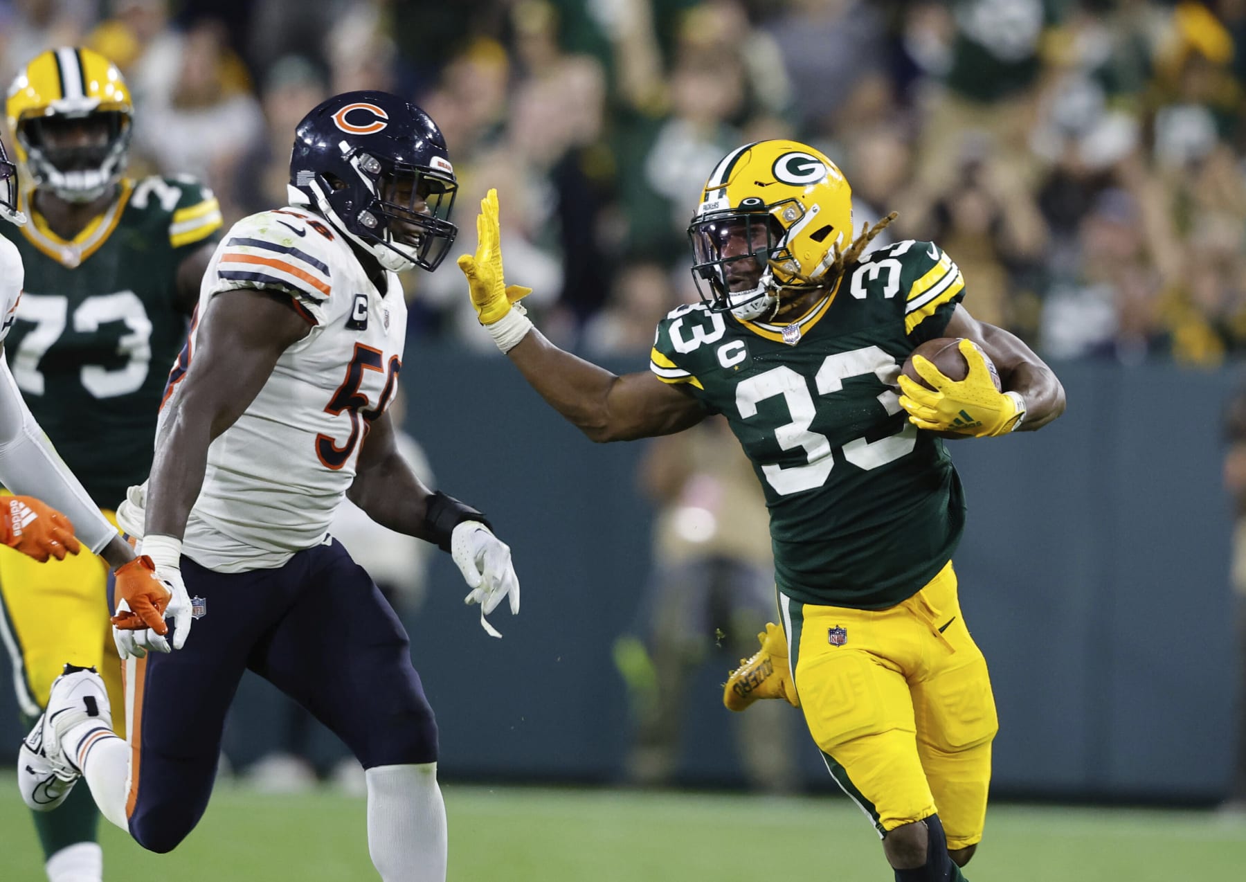 Green Bay Packers running back Aaron Jones (33) runs for yardage during an NFL game against the Chicago Bears Sunday, Sept. 18, 2022, in Green Bay, Wis. (AP Photo/Jeffrey Phelps)