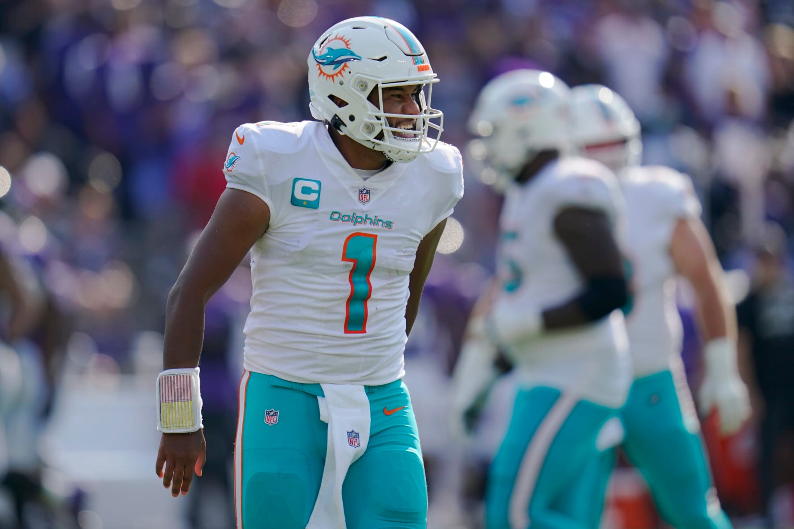 Miami Dolphins quarterback Tua Tagovailoa (1) celebrates after his touchdown pass to wide receiver Tyreek Hill during the second half of an NFL football game against the Baltimore Ravens, Sunday, Sept. 18, 2022, in Baltimore. (AP Photo/Julio Cortez)