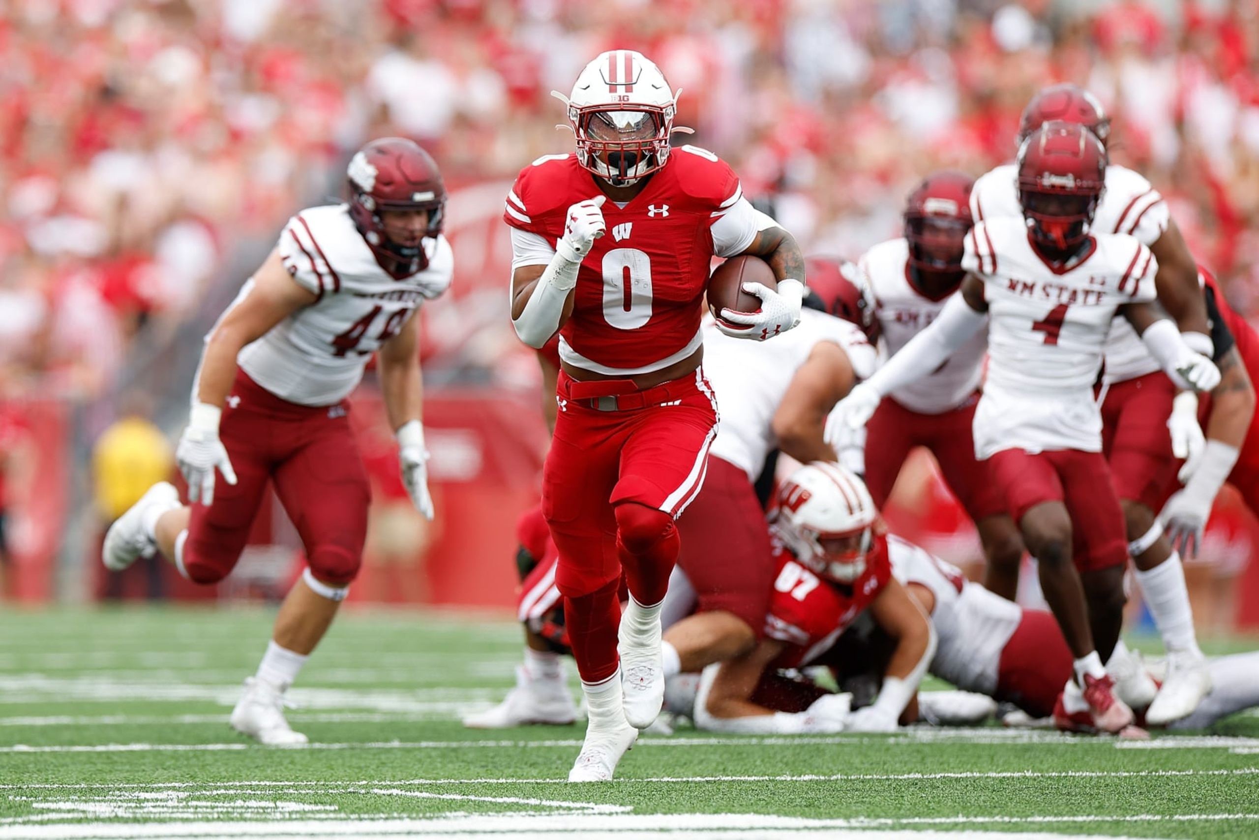 MADISON, WISCONSIN - SEPTEMBER 17: Braelon Allen #0 of the Wisconsin Badgers scores on a 39-yard touchdown run in the first quarter against the New Mexico State Aggies at Camp Randall Stadium on September 17, 2022 in Madison, Wisconsin. (Photo by John Fisher/Getty Images) MADISON, WISCONSIN - SEPTEMBER 17: Braelon Allen #0 of the Wisconsin Badgers scores on a 39-yard touchdown run in the first quarter against the New Mexico State Aggies at Camp Randall Stadium on September 17, 2022 in Madison, Wisconsin. (Photo by John Fisher/Getty Images)