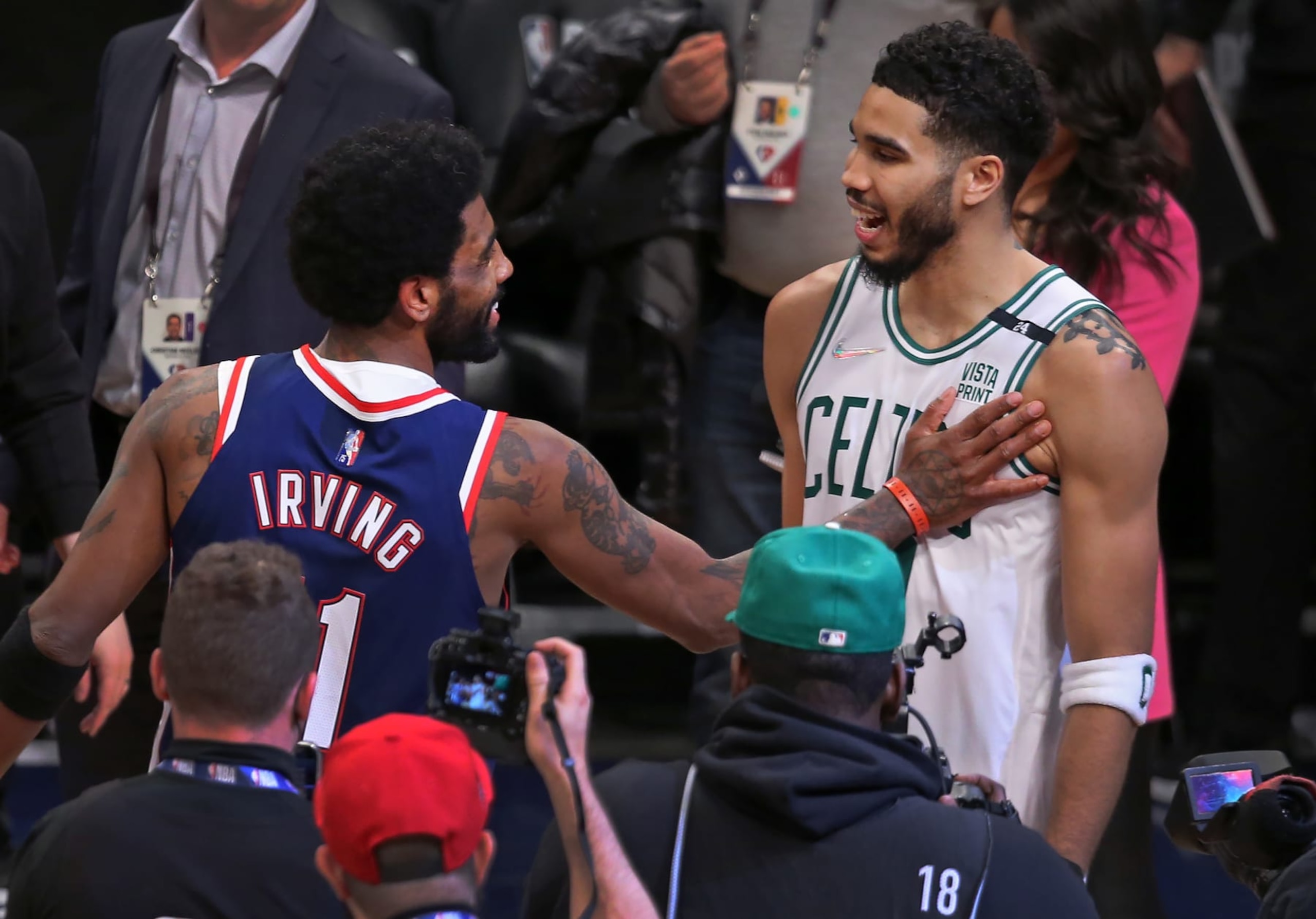 Brooklyn - April 25: The Nets Kyrie Irving (left) has a pat and a big smile for the Celtics Jayson Tatum (right) after Boston won to sweep the series. The Boston Celtics visited the Brooklyn Nets for Game Four of their first round NBA playoff series at Barclays Center in Brooklyn, NY on April 25, 2022. (Photo by Jim Davis/The Boston Globe via Getty Images)