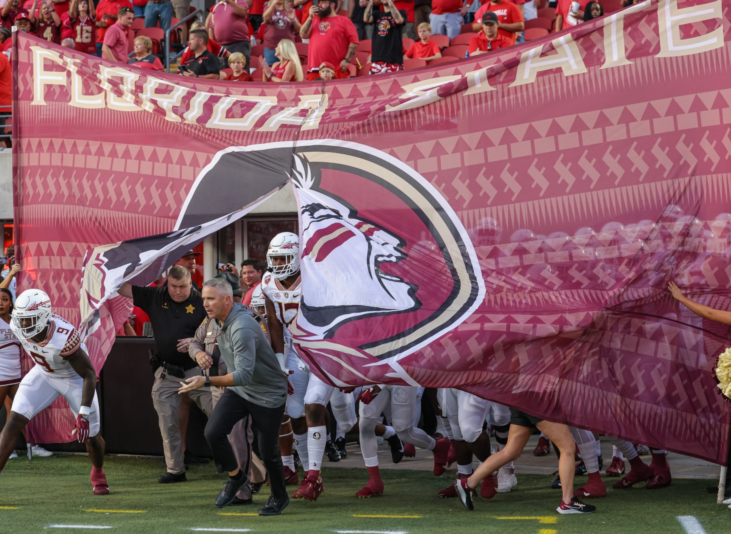 LOUISVILLE, KY - SEPTEMBER 16: Head coach Mike Norvell of the Florida State Seminoles and team take the field before the game against the Louisville Cardinals at Cardinal Stadium on September 16, 2022 in Louisville, Kentucky. (Photo by Michael Hickey/Getty Images)