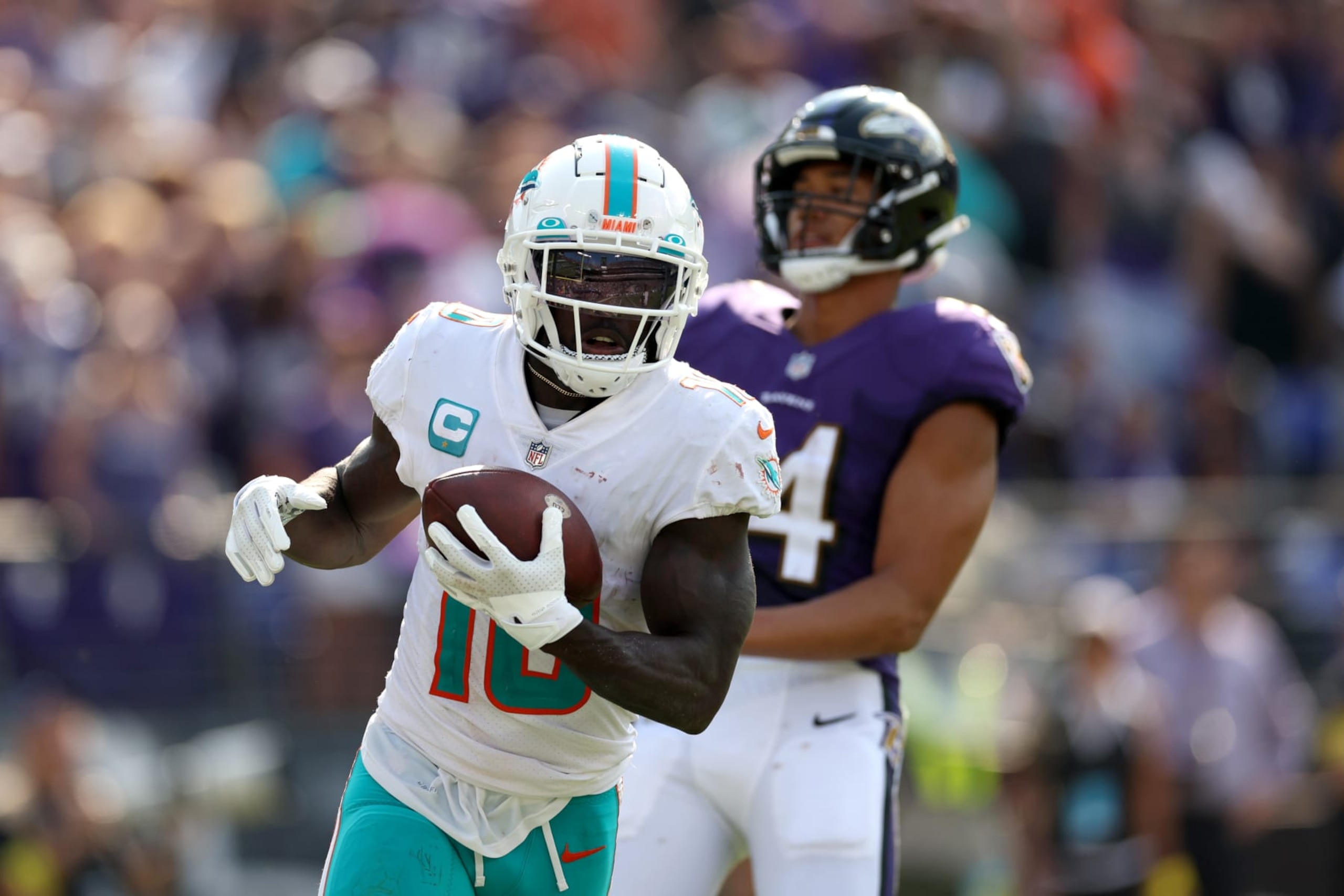 BALTIMORE, MARYLAND - SEPTEMBER 18: Wide receiver Tyreek Hill #10 of the Miami Dolphins catches a second half touchdown pass in front of safety Kyle Hamilton #14 of the Baltimore Ravens at M&T Bank Stadium on September 18, 2022 in Baltimore, Maryland. (Photo by Rob Carr/Getty Images)