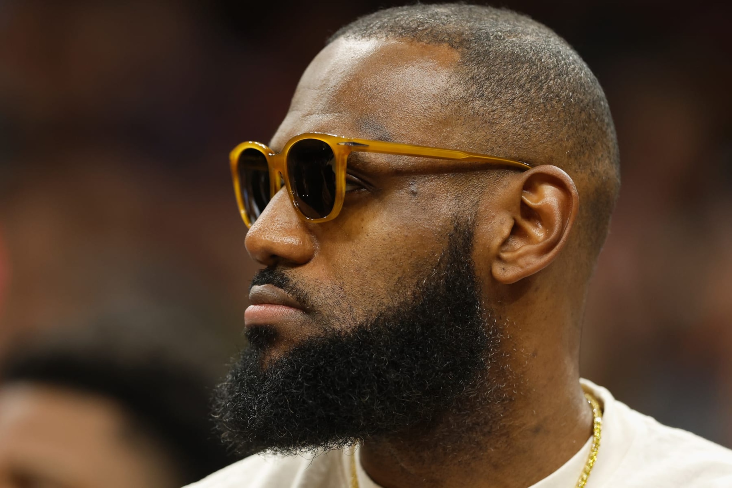 PHOENIX, ARIZONA - APRIL 05: LeBron James #6 of the Los Angeles Lakers watches from the bench during the first half of the NBA game against the Phoenix Suns at Footprint Center on April 05, 2022 in Phoenix, Arizona.   The Suns defeated the Lakers 121-110. NOTE TO USER: User expressly acknowledges and agrees that, by downloading and or using this photograph, User is consenting to the terms and conditions of the Getty Images License Agreement. (Photo by Christian Petersen/Getty Images)