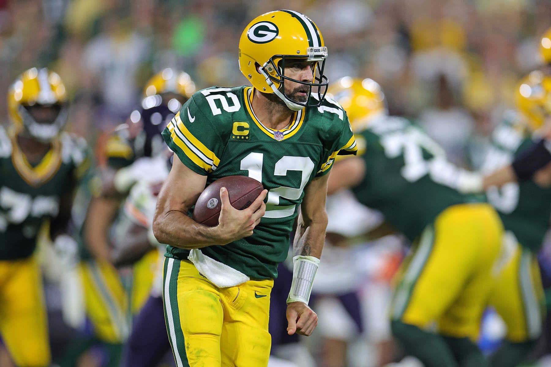 GREEN BAY, WISCONSIN - SEPTEMBER 18: Aaron Rodgers #12 of the Green Bay Packers runs for yards during a game against the Chicago Bears at Lambeau Field on September 18, 2022 in Green Bay, Wisconsin. The Packers defeated the Bears 27-10.  (Photo by Stacy Revere/Getty Images)