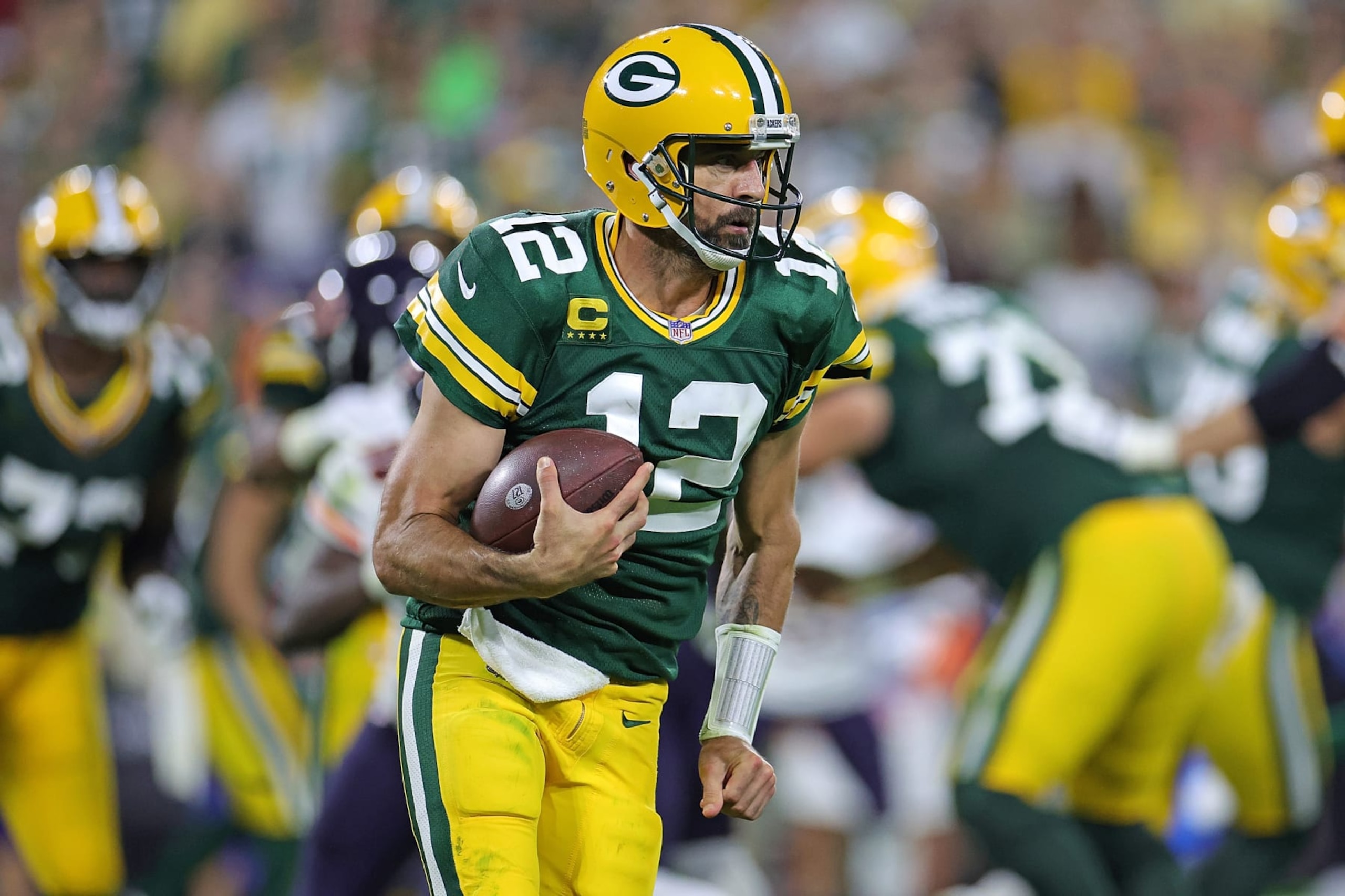 GREEN BAY, WISCONSIN - SEPTEMBER 18: Aaron Rodgers #12 of the Green Bay Packers runs for yards during a game against the Chicago Bears at Lambeau Field on September 18, 2022 in Green Bay, Wisconsin. The Packers defeated the Bears 27-10.  (Photo by Stacy Revere/Getty Images)