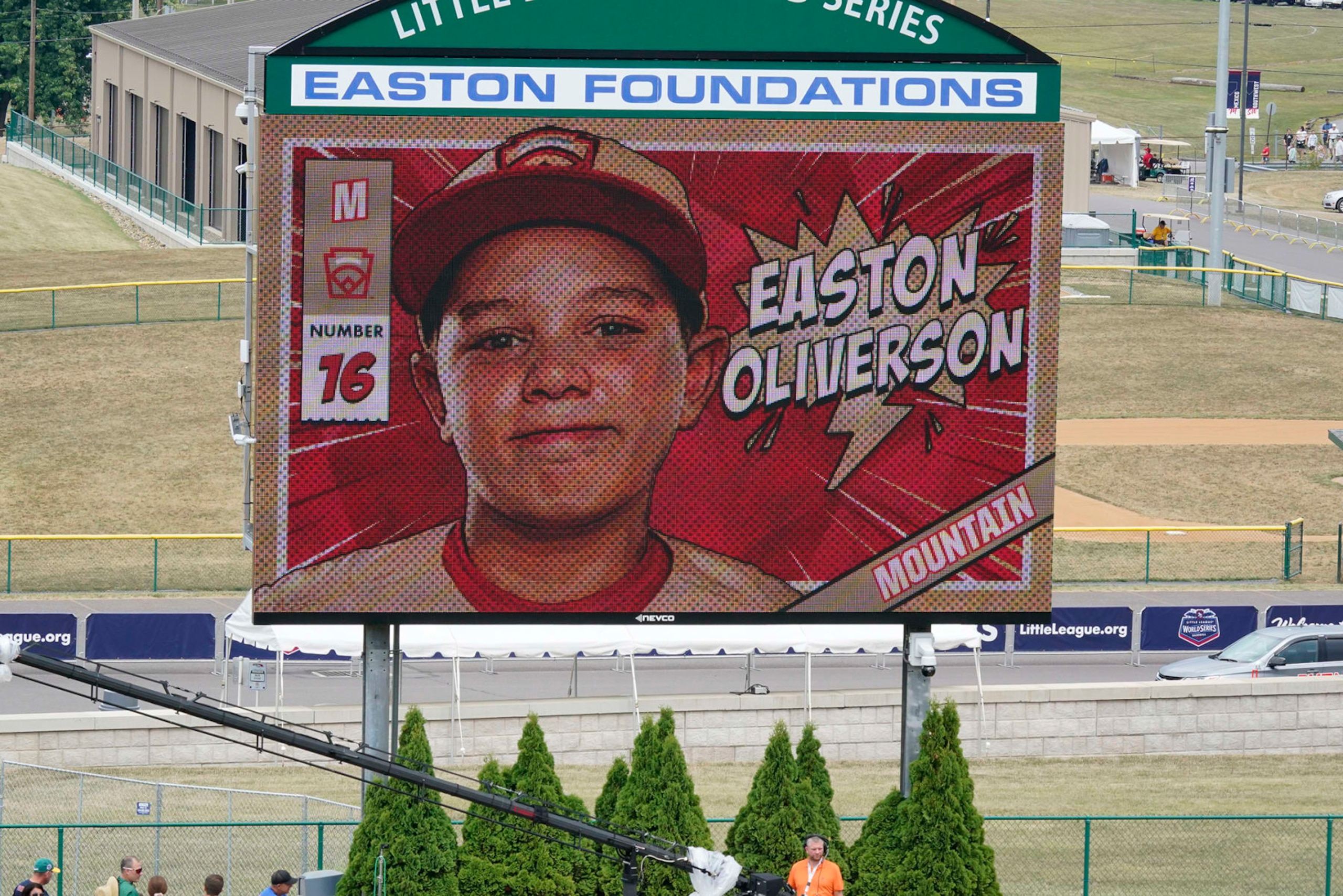 A picture of Mountain Region Champion Little League team member Easton Oliverson, from Santa Clara, Utah, is shown on the scoreboard at Volunteer Stadium during the opening ceremony of the 2022 Little League World Series baseball tournament in South Williamsport, Pa., Wednesday, Aug 17, 2022. Oliverson was injured when he fell out of a bunk bed at the dormitory complex. (AP Photo/Gene J. Puskar)