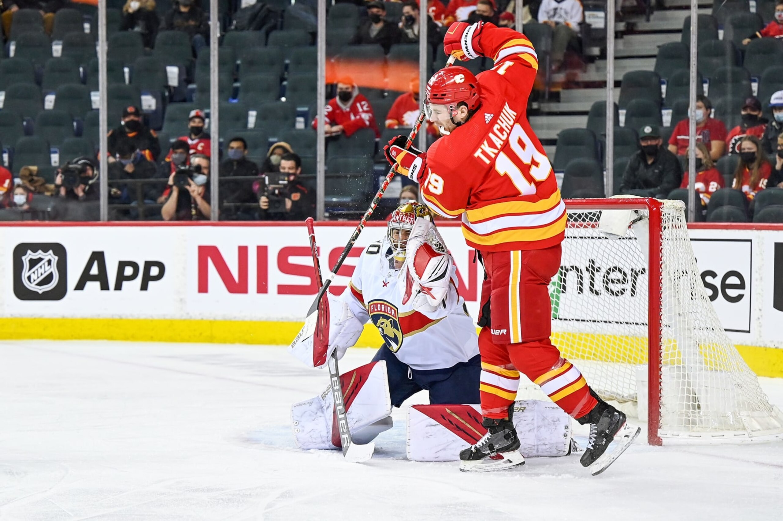CALGARY, AB - JANUARY 18: Florida Panthers Goalie Spencer Knight (30) makes a glove save while Calgary Flames Right Wing Matthew Tkachuk (19) tries to tip the puck during the first period of an NHL game where the Calgary Flames hosted the Florida Panthers on January 18, 2022, at the Scotiabank Saddledome in Calgary, AB. (Photo by Brett Holmes/Icon Sportswire via Getty Images)
