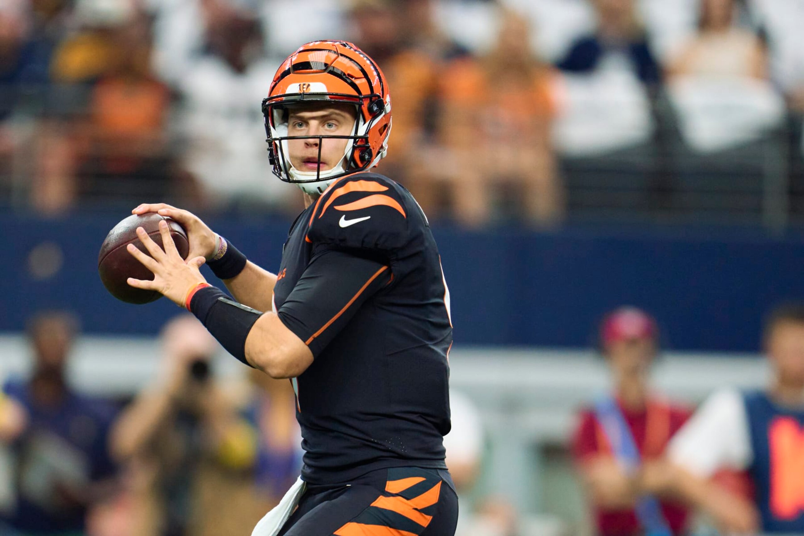 ARLINGTON, TX - SEPTEMBER 18: Joe Burrow #9 of the Cincinnati Bengals drops back to pass against the Dallas Cowboys at AT&T Stadium on September 18, 2022 in Arlington, Texas. (Photo by Cooper Neill/Getty Images) ARLINGTON, TX - SEPTEMBER 18: Joe Burrow #9 of the Cincinnati Bengals drops back to pass against the Dallas Cowboys at AT&T Stadium on September 18, 2022 in Arlington, Texas. (Photo by Cooper Neill/Getty Images)