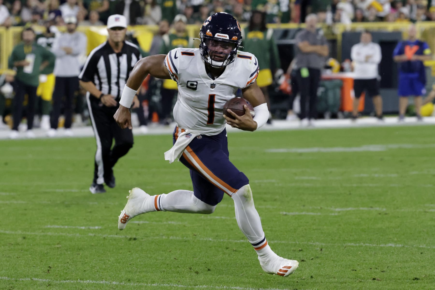 Chicago Bears quarterback Justin Fields (1) runs up field during the second half of an NFL football game against the Green Bay Packers Sunday, Sept. 18, 2022, in Green Bay, Wis. (AP Photo/Mike Roemer)