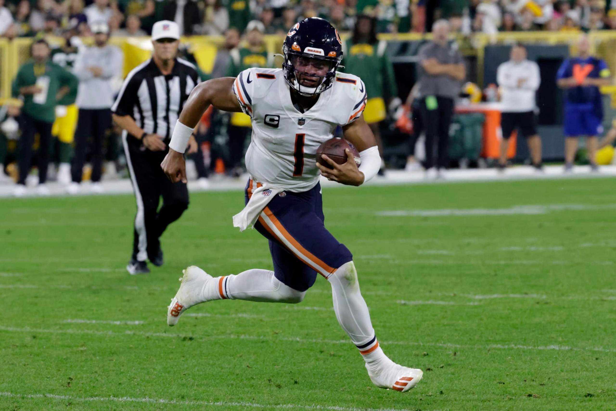 Chicago Bears quarterback Justin Fields (1) runs up field during the second half of an NFL football game against the Green Bay Packers Sunday, Sept. 18, 2022, in Green Bay, Wis. (AP Photo/Mike Roemer)