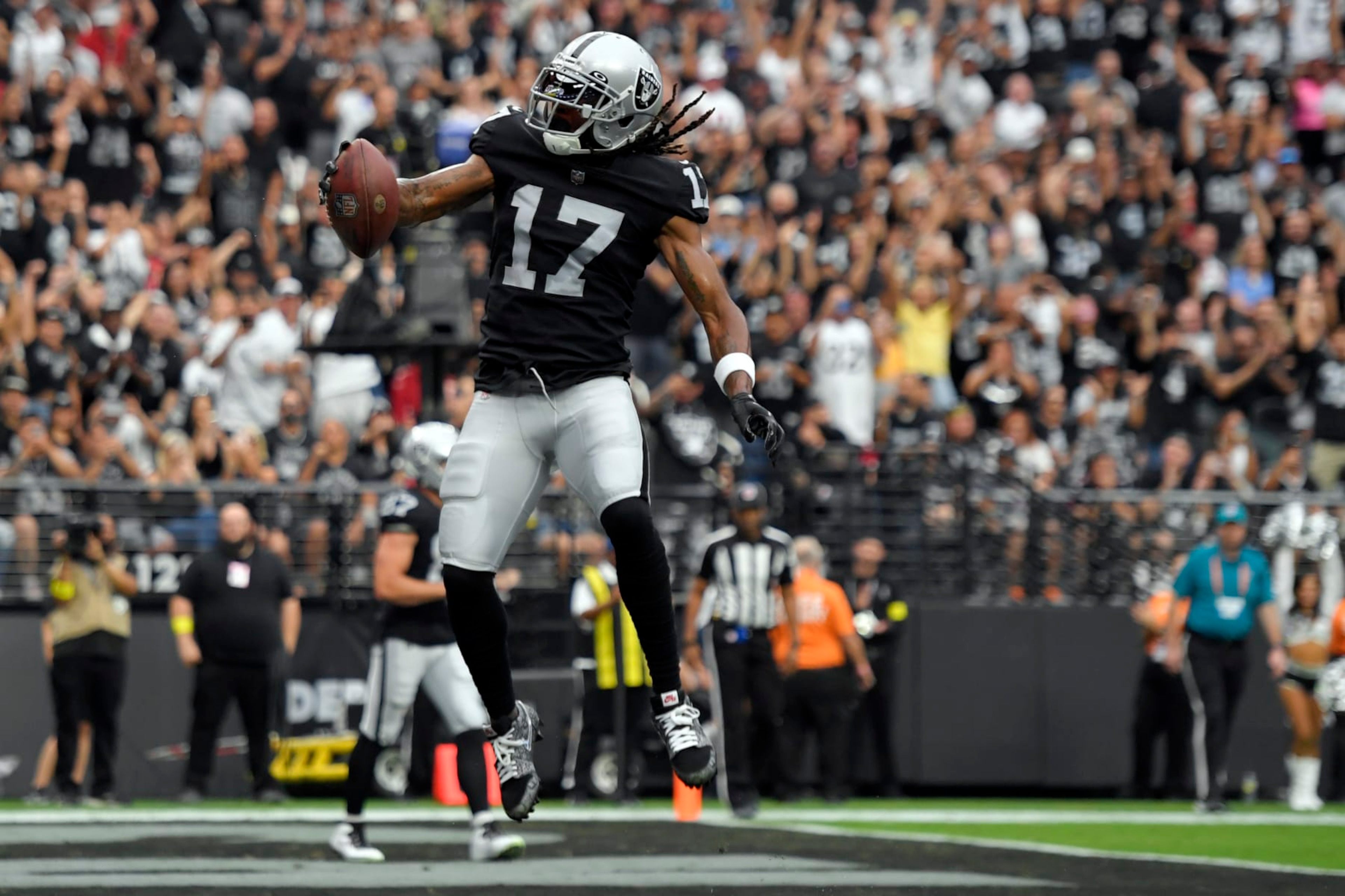 Las Vegas Raiders wide receiver Davante Adams (17) celebrates after a touchdown reception during the first half of an NFL football game against the Arizona Cardinals Sunday, Sept. 18, 2022, in Las Vegas. (AP Photo/David Becker) Las Vegas Raiders wide receiver Davante Adams (17) celebrates after a touchdown reception during the first half of an NFL football game against the Arizona Cardinals Sunday, Sept. 18, 2022, in Las Vegas. (AP Photo/David Becker)