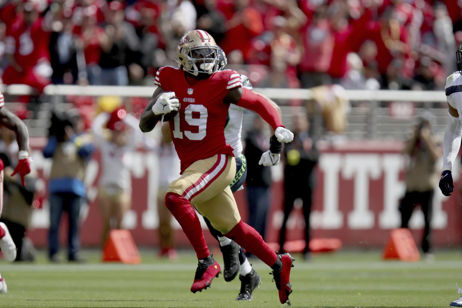 San Francisco 49ers wide receiver Deebo Samuel (19) runs the ball during an NFL football game against the Seattle Seahawks, Sunday, Sept. 18, 2022, in Santa Clara, Calif. (AP Photo/Scot Tucker)