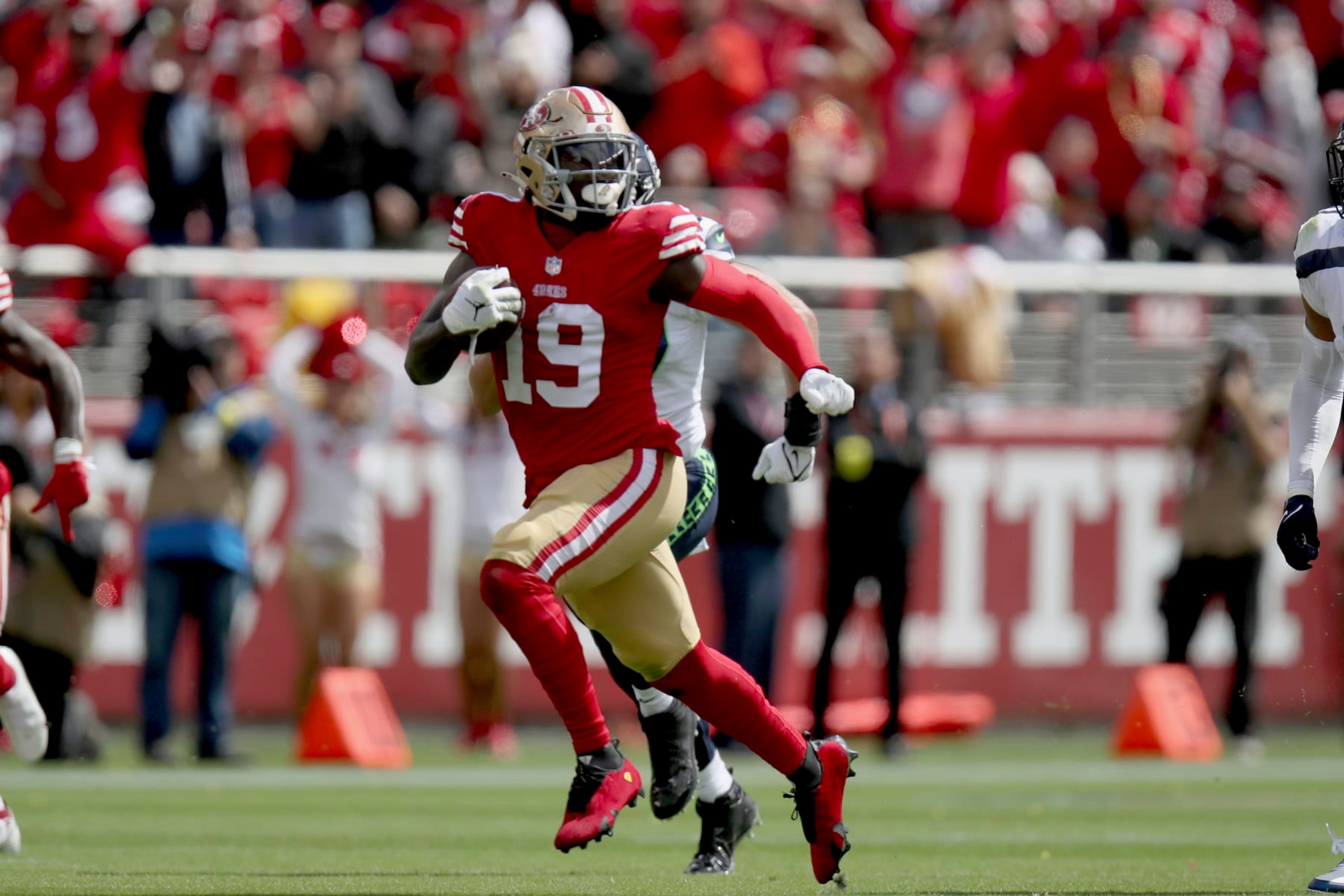 San Francisco 49ers wide receiver Deebo Samuel (19) runs the ball during an NFL football game against the Seattle Seahawks, Sunday, Sept. 18, 2022, in Santa Clara, Calif. (AP Photo/Scot Tucker)