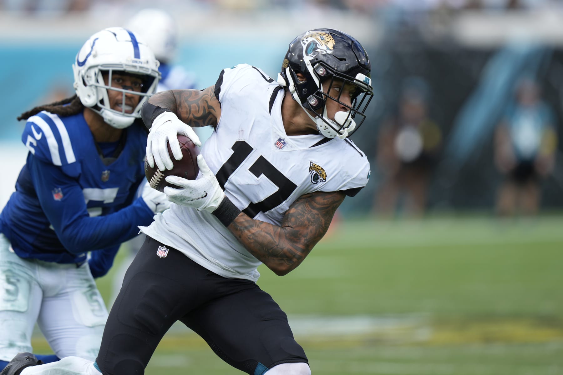 Jacksonville Jaguars tight end Evan Engram (17) runs after the catch as he is pursued by Indianapolis Colts cornerback Stephon Gilmore (5) during an NFL football game, Sunday, September 18, 2022 in Jacksonville, FL. The Jaguars defeat the Colts 24-0. (Peter Joneleit via AP)