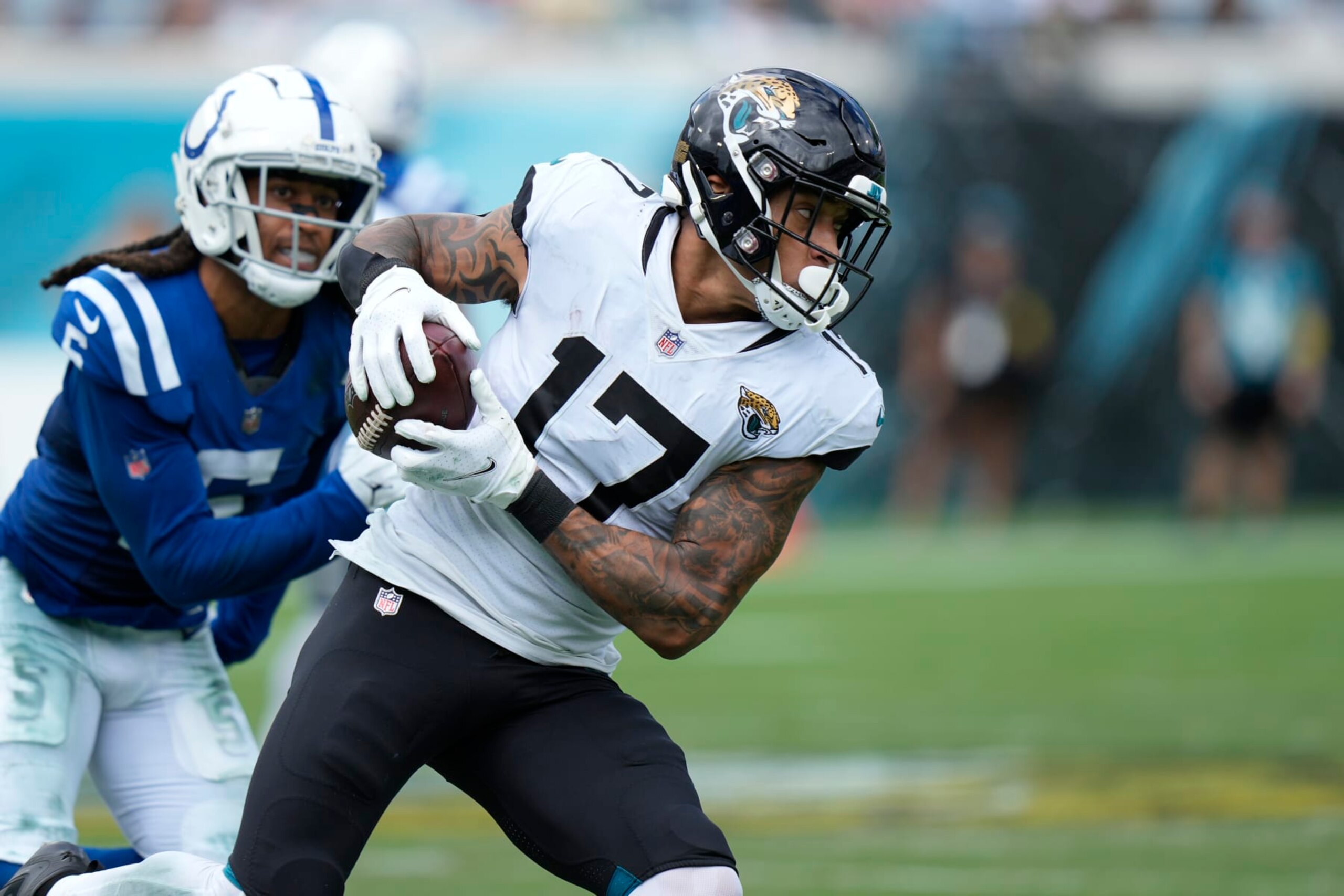 Jacksonville Jaguars tight end Evan Engram (17) runs after the catch as he is pursued by Indianapolis Colts cornerback Stephon Gilmore (5) during an NFL football game, Sunday, September 18, 2022 in Jacksonville, FL. The Jaguars defeat the Colts 24-0. (Peter Joneleit via AP)