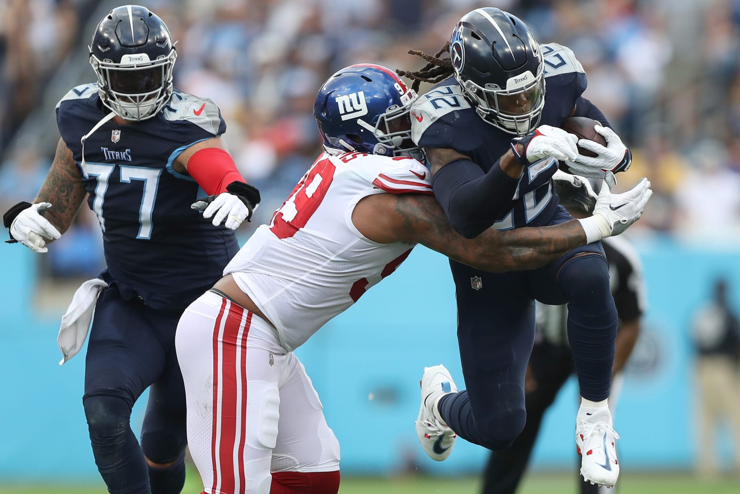 NASHVILLE, TENNESSEE - SEPTEMBER 11: Defensive end Leonard Williams #99 of the New York Giants tackles running back Derrick Henry #22 of the Tennessee Titans during the first half at Nissan Stadium on September 11, 2022 in Nashville, Tennessee. (Photo by Justin Ford/Getty Images)