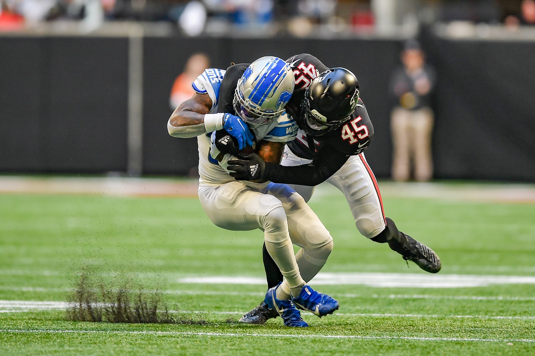 ATLANTA, GA  DECEMBER 26:  Atlanta inside linebacker Deion Jones (45) makes a tackle on Detroit running back Jamaal Williams (30) during the NFL game between the Detroit Lions and the Atlanta Falcons on December 26th, 2021 at Mercedes-Benz Stadium in Atlanta, GA.  (Photo by Rich von Biberstein/Icon Sportswire via Getty Images)