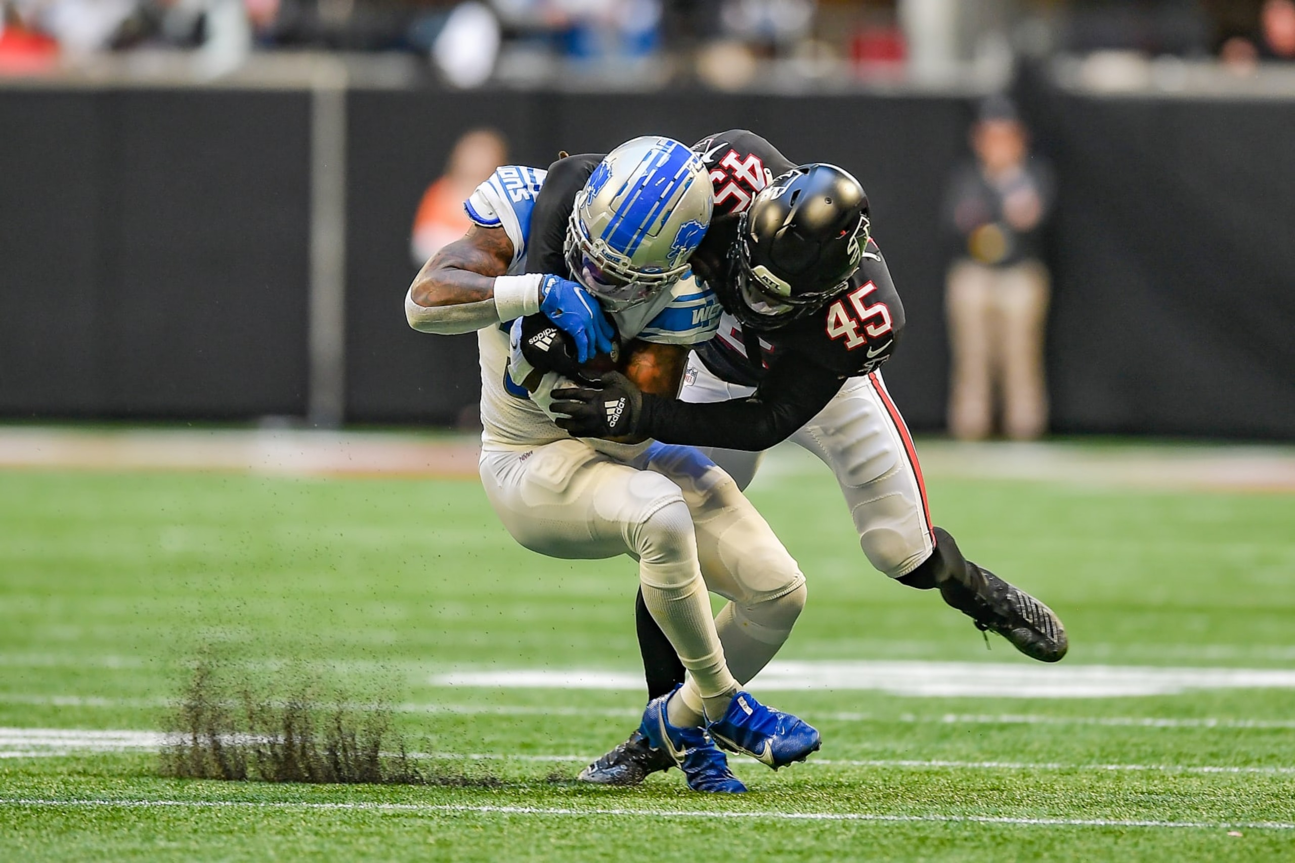ATLANTA, GA  DECEMBER 26:  Atlanta inside linebacker Deion Jones (45) makes a tackle on Detroit running back Jamaal Williams (30) during the NFL game between the Detroit Lions and the Atlanta Falcons on December 26th, 2021 at Mercedes-Benz Stadium in Atlanta, GA.  (Photo by Rich von Biberstein/Icon Sportswire via Getty Images)