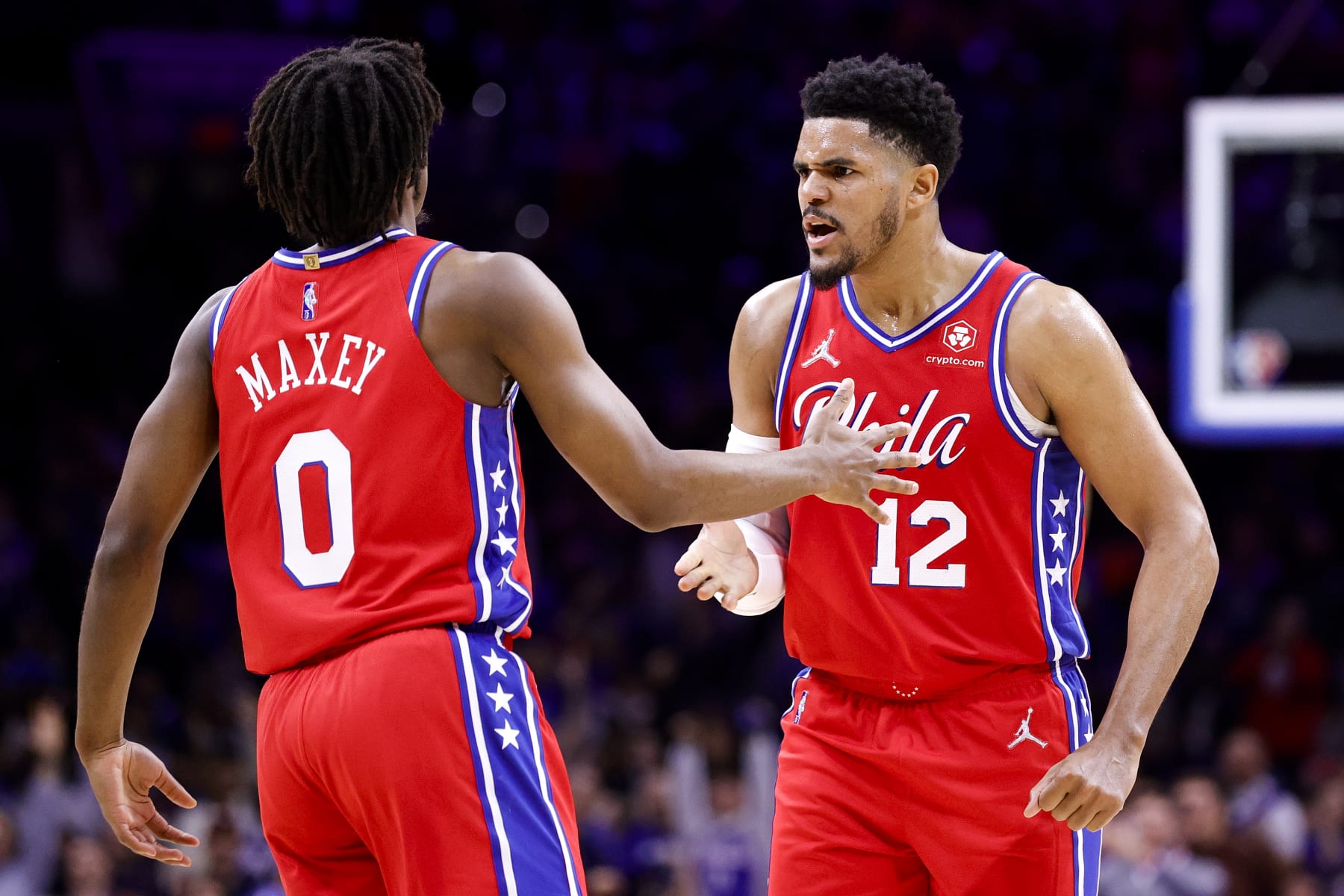 PHILADELPHIA, PENNSYLVANIA - APRIL 18: Tyrese Maxey #0 (L) and Tobias Harris #12 of the Philadelphia 76ers celebrate against the Toronto Raptors during Game Two of the Eastern Conference First Round at Wells Fargo Center on April 18, 2022 in Philadelphia, Pennsylvania. NOTE TO USER: User expressly acknowledges and agrees that, by downloading and or using this photograph, User is consenting to the terms and conditions of the Getty Images License Agreement. (Photo by Tim Nwachukwu/Getty Images)