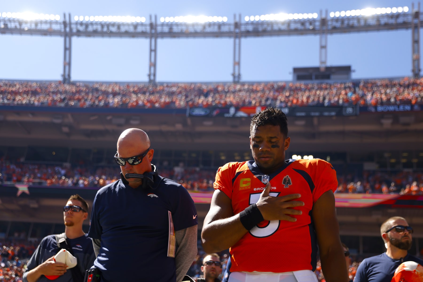 DENVER, COLORADO - SEPTEMBER 18: Head coach Nathaniel Hackett and Russell Wilson #3 of the Denver Broncos take a moment during the national anthem prior to playing the Houston Texans at Empower Field At Mile High on September 18, 2022 in Denver, Colorado. (Photo by Justin Edmonds/Getty Images)
