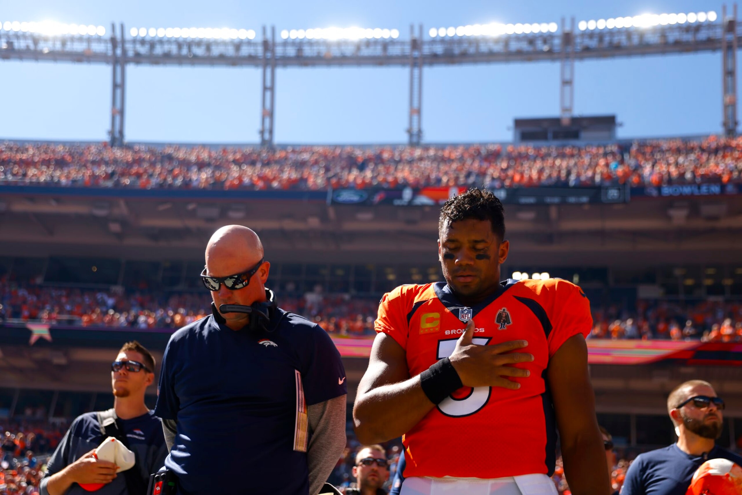 DENVER, COLORADO - SEPTEMBER 18: Head coach Nathaniel Hackett and Russell Wilson #3 of the Denver Broncos take a moment during the national anthem prior to playing the Houston Texans at Empower Field At Mile High on September 18, 2022 in Denver, Colorado. (Photo by Justin Edmonds/Getty Images)