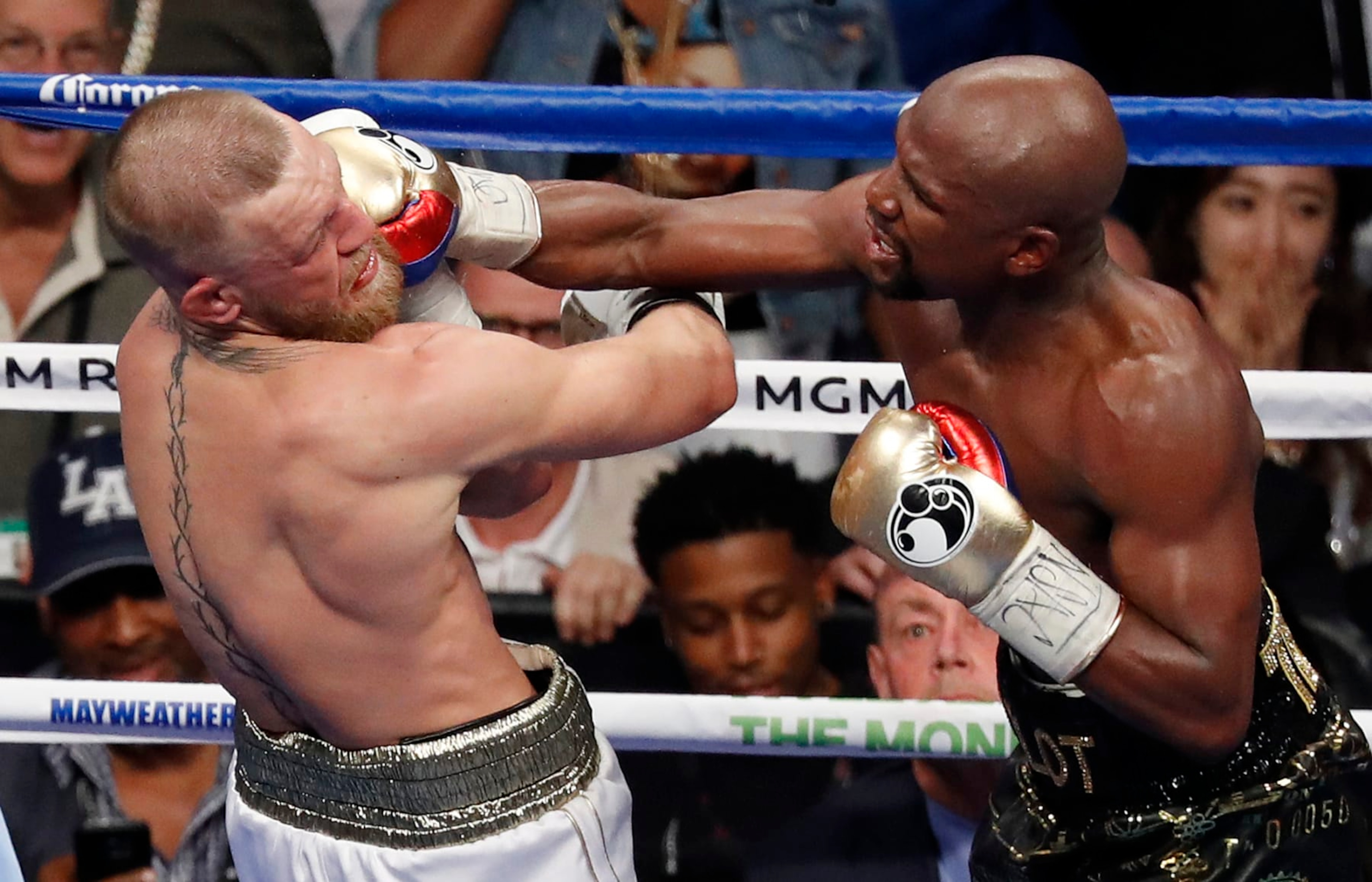 FILE - In this Aug. 26, 2017, file photo, Floyd Mayweather Jr. hits Conor McGregor in a super welterweight boxing match in Las Vegas. The AP reported on Sept. 1, 2017, that a story claiming a boxing promoter connected to the fight was found shot dead in Washington, D.C. is a hoax. (AP Photo/Eric Jamison, File) FILE - In this Aug. 26, 2017, file photo, Floyd Mayweather Jr. hits Conor McGregor in a super welterweight boxing match in Las Vegas. The AP reported on Sept. 1, 2017, that a story claiming a boxing promoter connected to the fight was found shot dead in Washington, D.C. is a hoax. (AP Photo/Eric Jamison, File)