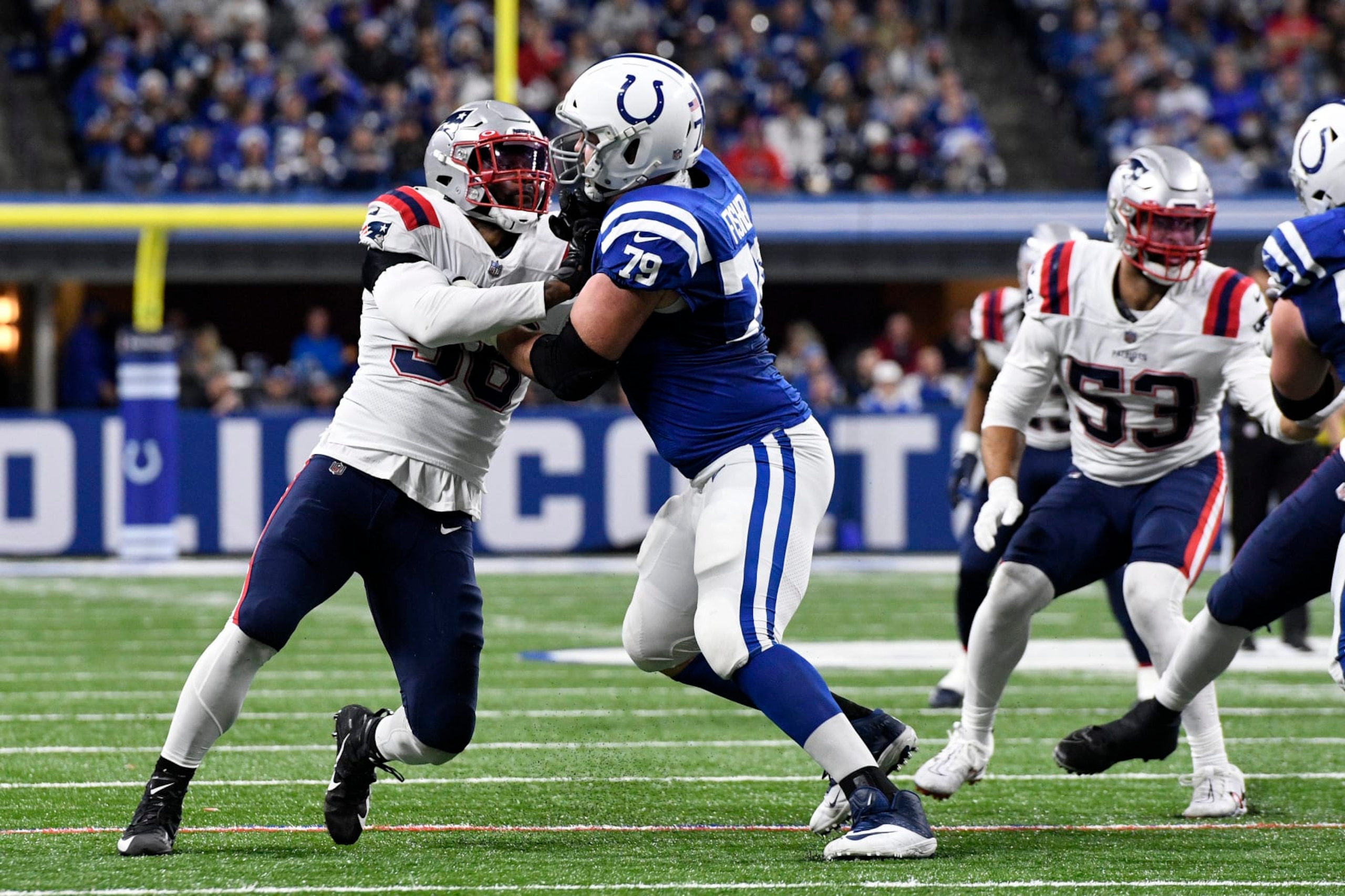 INDIANAPOLIS, IN - DECEMBER 18: Indianapolis Colts Offensive Tackle Eric Fisher (79) blocks New England Patriots Linebacker Brandon King (36) during the NFL football game between the New England Patriots and the Indianapolis Colts on December 18, 2021, at Lucas Oil Stadium in Indianapolis, Indiana. (Photo by Michael Allio/Icon Sportswire via Getty Images)