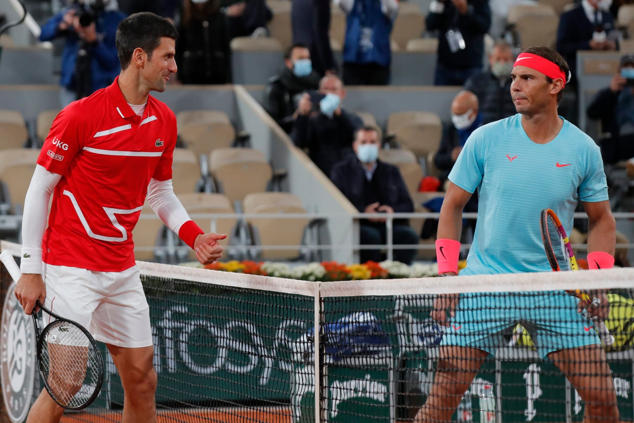 FILE - Serbia's Novak Djokovic, left, and Spain's Rafael Nadal look at each other as they pose for images prior to the final match of the French Open tennis tournament at Roland Garros stadium in Paris, France, in this Sunday, Oct. 11, 2020, file photo. When this year’s French Open starts Sunday, May 30, 2021, in Paris, Nadal will be seeking his 21st Grand Slam title to break a tie with Roger Federer for the men’s record, while Djokovic will try to close the gap with those two by earning his 19th.(AP Photo/Michel Euler, File)