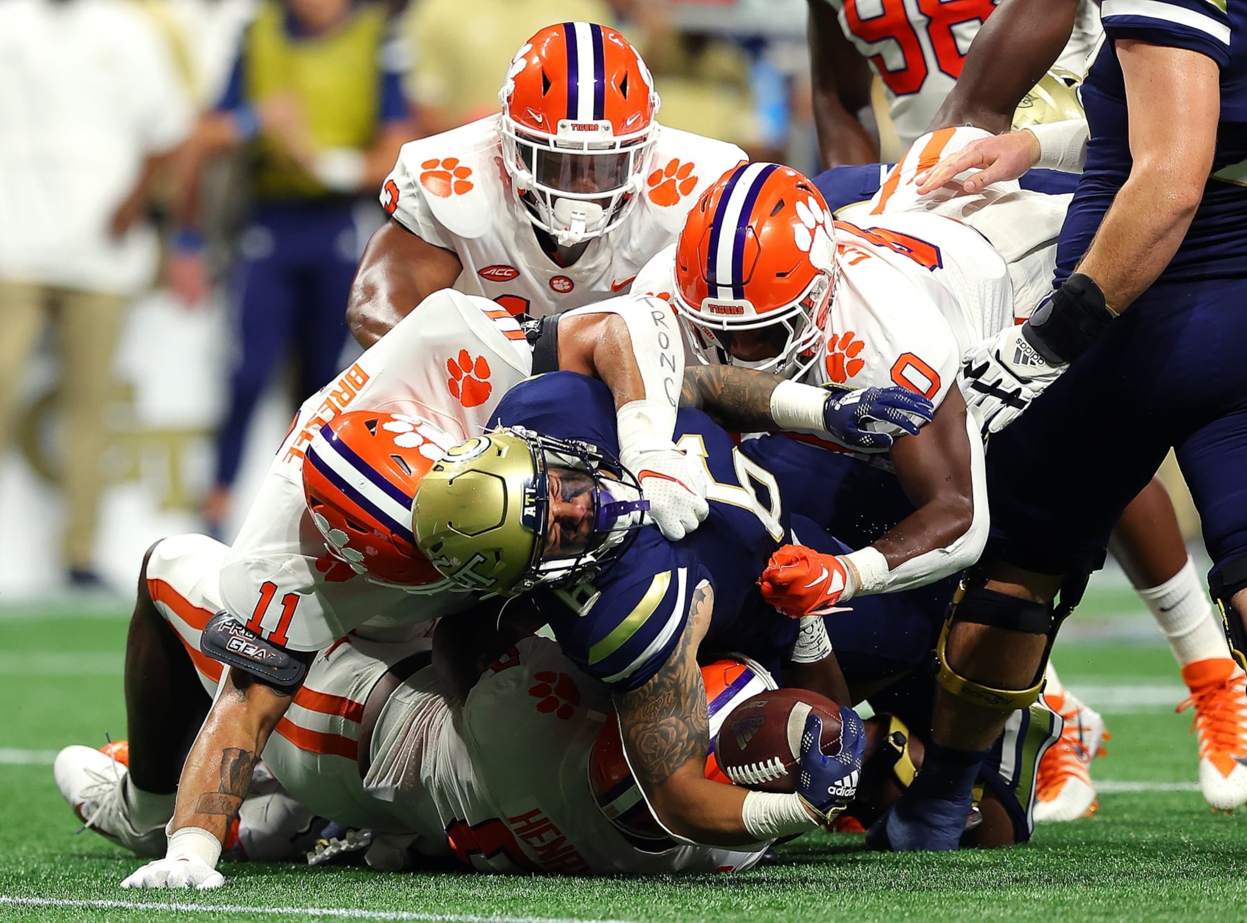 ATLANTA, GEORGIA - SEPTEMBER 05: Dylan McDuffie #6 of the Georgia Tech Yellow Jackets is tackled by Bryan Bresee #11, K.J. Henry #5, Barrett Carter #0 and Tyler Davis #13 of the Clemson Tigers during the first quarter at Mercedes-Benz Stadium on September 05, 2022 in Atlanta, Georgia. (Photo by Kevin C. Cox/Getty Images) ATLANTA, GEORGIA - SEPTEMBER 05: Dylan McDuffie #6 of the Georgia Tech Yellow Jackets is tackled by Bryan Bresee #11, K.J. Henry #5, Barrett Carter #0 and Tyler Davis #13 of the Clemson Tigers during the first quarter at Mercedes-Benz Stadium on September 05, 2022 in Atlanta, Georgia. (Photo by Kevin C. Cox/Getty Images)