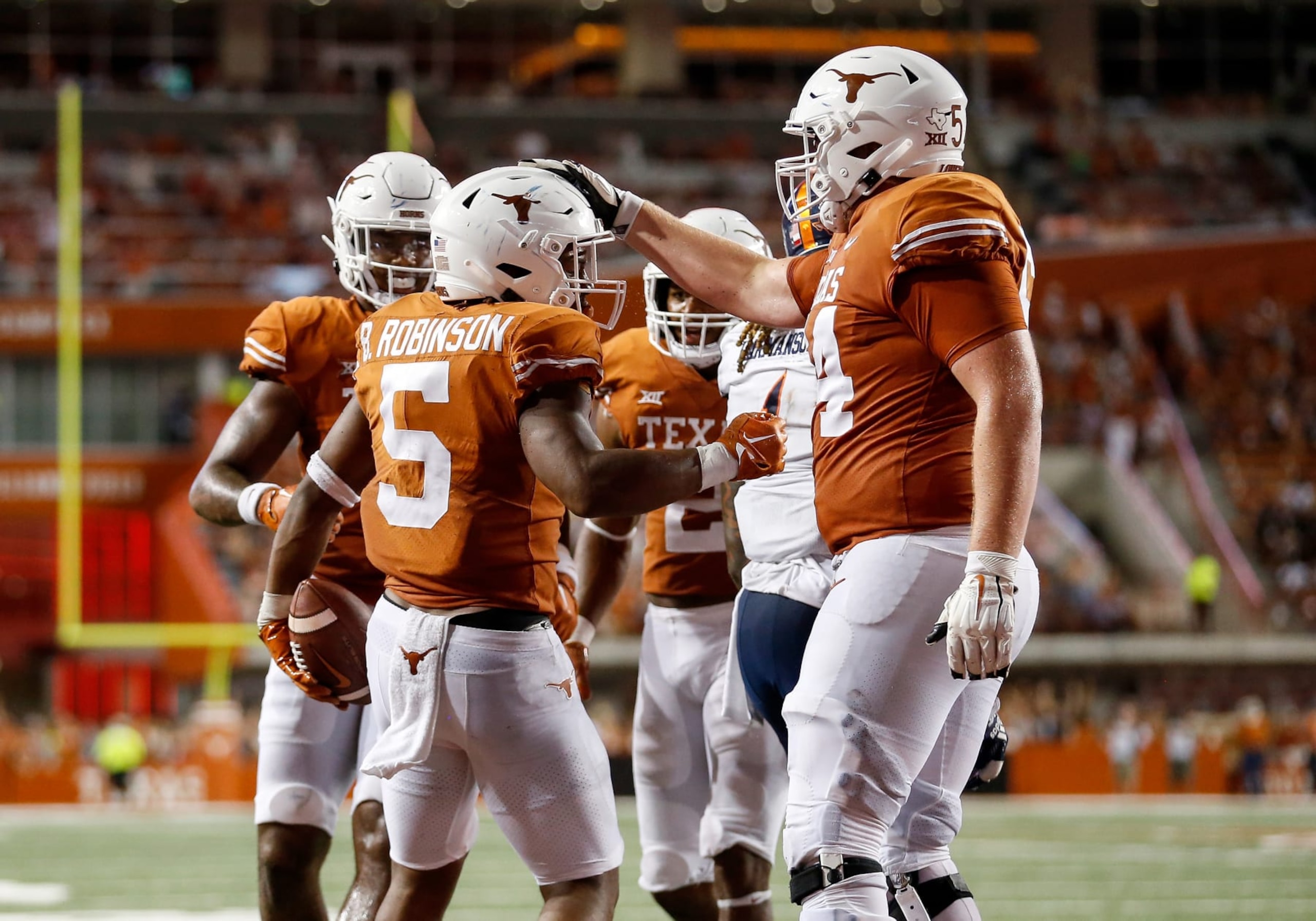 AUSTIN, TEXAS - SEPTEMBER 17: Cole Hutson #54 of the Texas Longhorns congratulates Bijan Robinson #5 after a rushing touchdown in the second quarter against the UTSA Roadrunners at Darrell K Royal-Texas Memorial Stadium on September 17, 2022 in Austin, Texas. (Photo by Tim Warner/Getty Images)