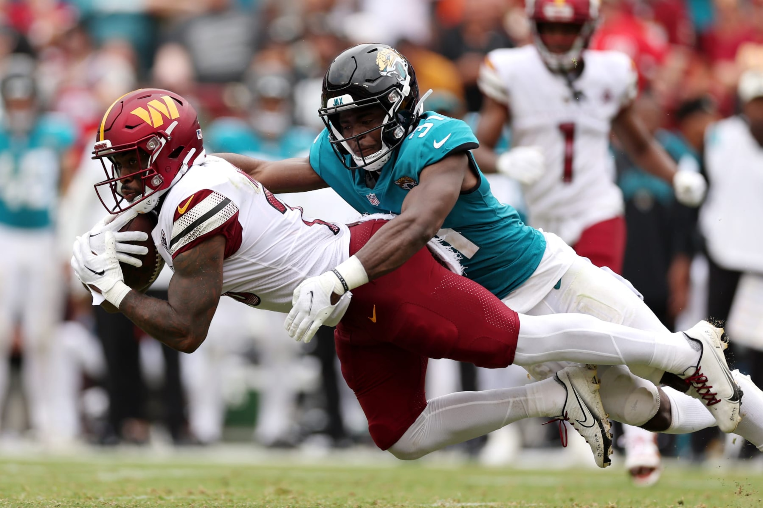 LANDOVER, MARYLAND - SEPTEMBER 11: Darious Williams #31 of the Jacksonville Jaguars tackles J.D. McKissic #23 of the Washington Commanders during the first half at FedExField on September 11, 2022 in Landover, Maryland. (Photo by Patrick Smith/Getty Images)