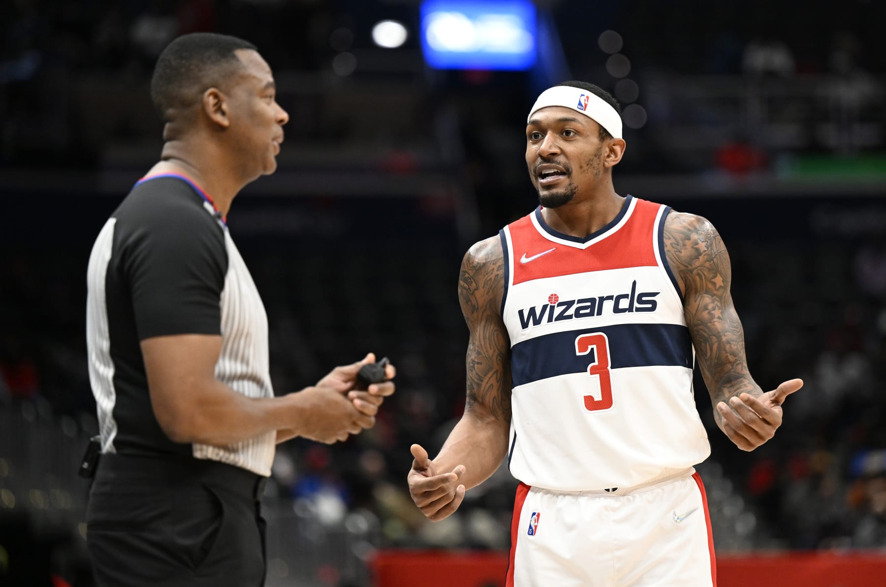 WASHINGTON, DC - JANUARY 25: Bradley Beal #3 of the Washington Wizards talks with official Sean Wright #4 during the game against the LA Clippers at Capital One Arena on January 25, 2022 in Washington, DC. NOTE TO USER: User expressly acknowledges and agrees that, by downloading and or using this photograph, User is consenting to the terms and conditions of the Getty Images License Agreement.  (Photo by G Fiume/Getty Images)