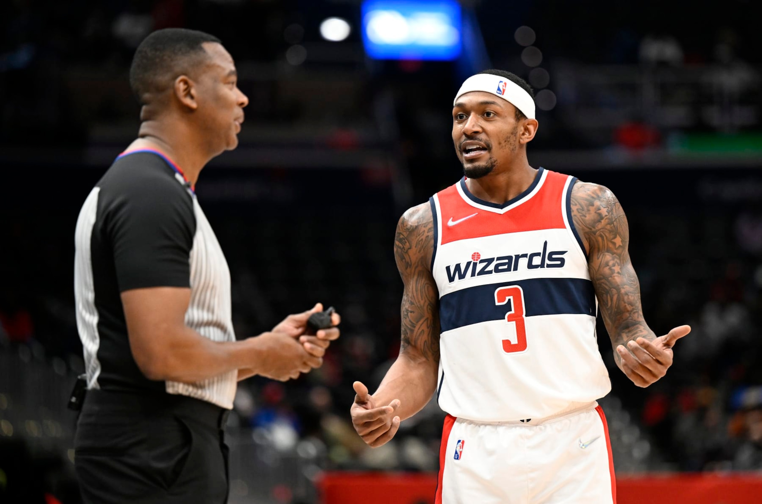 WASHINGTON, DC - JANUARY 25: Bradley Beal #3 of the Washington Wizards talks with official Sean Wright #4 during the game against the LA Clippers at Capital One Arena on January 25, 2022 in Washington, DC. NOTE TO USER: User expressly acknowledges and agrees that, by downloading and or using this photograph, User is consenting to the terms and conditions of the Getty Images License Agreement.  (Photo by G Fiume/Getty Images)