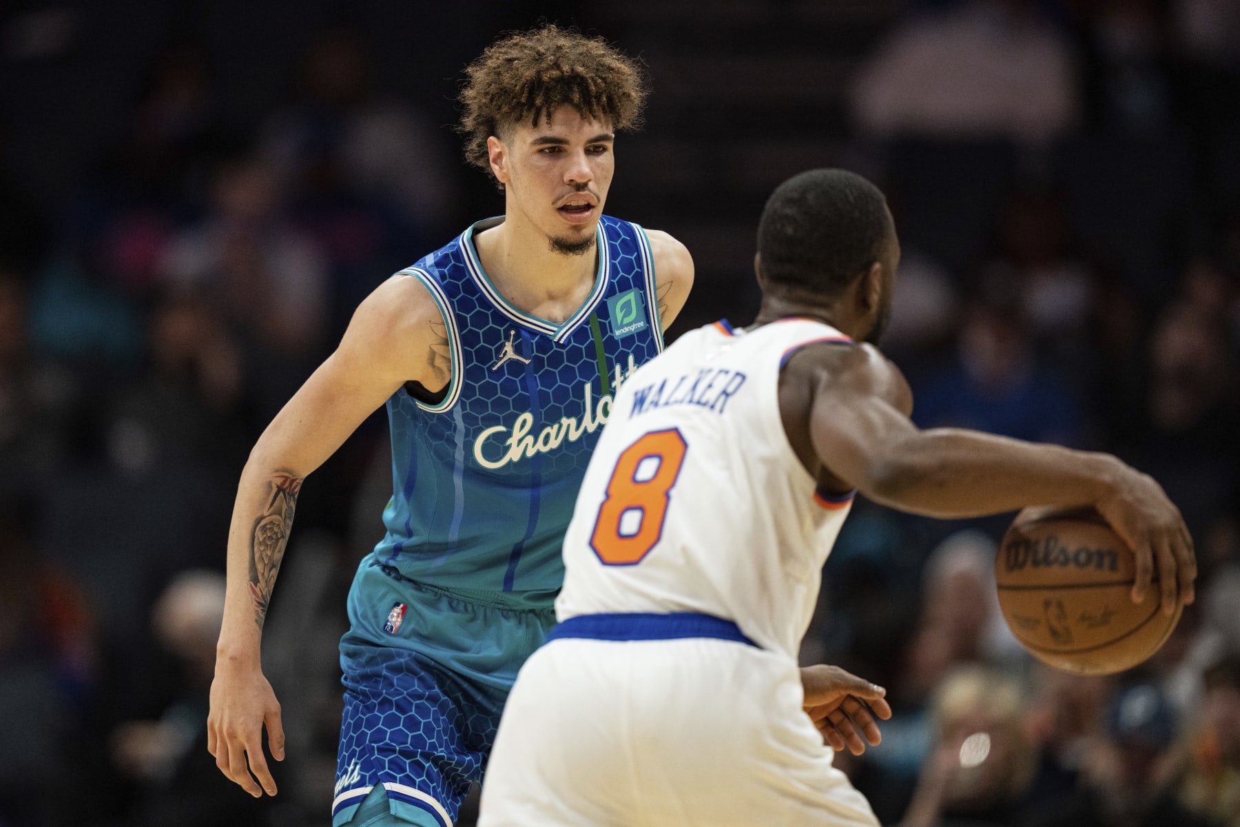 Charlotte Hornets guard LaMelo Ball (2) guards New York Knicks guard Kemba Walker (8) during the first half of an NBA basketball game in Charlotte, N.C., Friday, Nov. 12, 2021. (AP Photo/Jacob Kupferman)