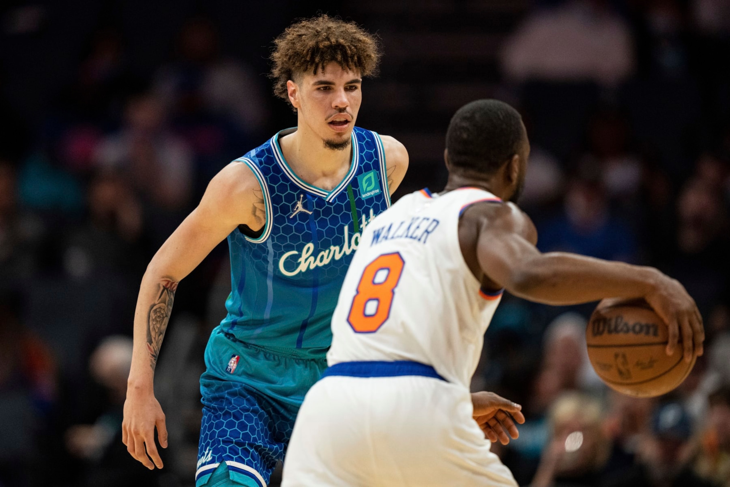 Charlotte Hornets guard LaMelo Ball (2) guards New York Knicks guard Kemba Walker (8) during the first half of an NBA basketball game in Charlotte, N.C., Friday, Nov. 12, 2021. (AP Photo/Jacob Kupferman)