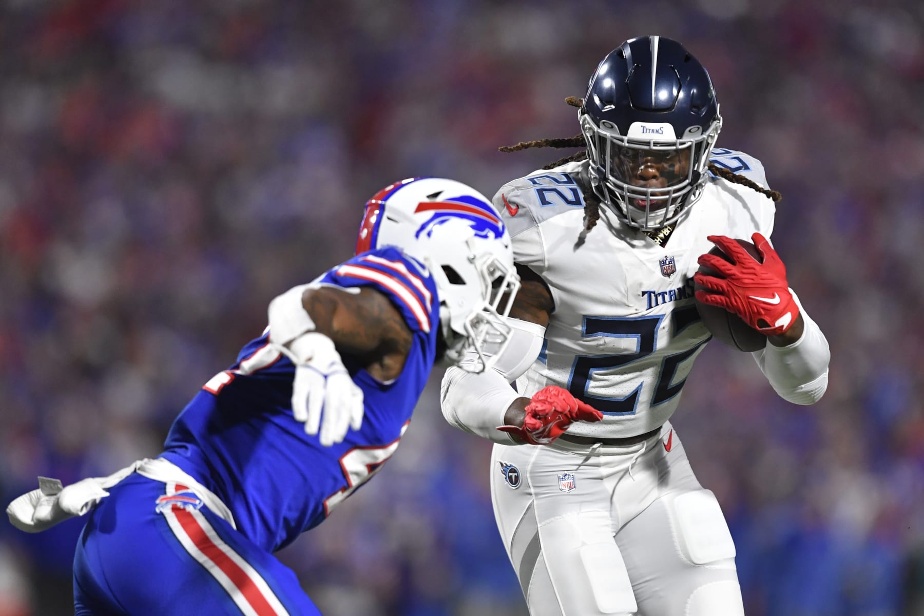 Tennessee Titans' Derrick Henry, right, rushes past Buffalo Bills' Christian Benford during the first half of an NFL football game Monday, Sept. 19, 2022, in Orchard Park, N.Y. (AP Photo/Adrian Kraus)