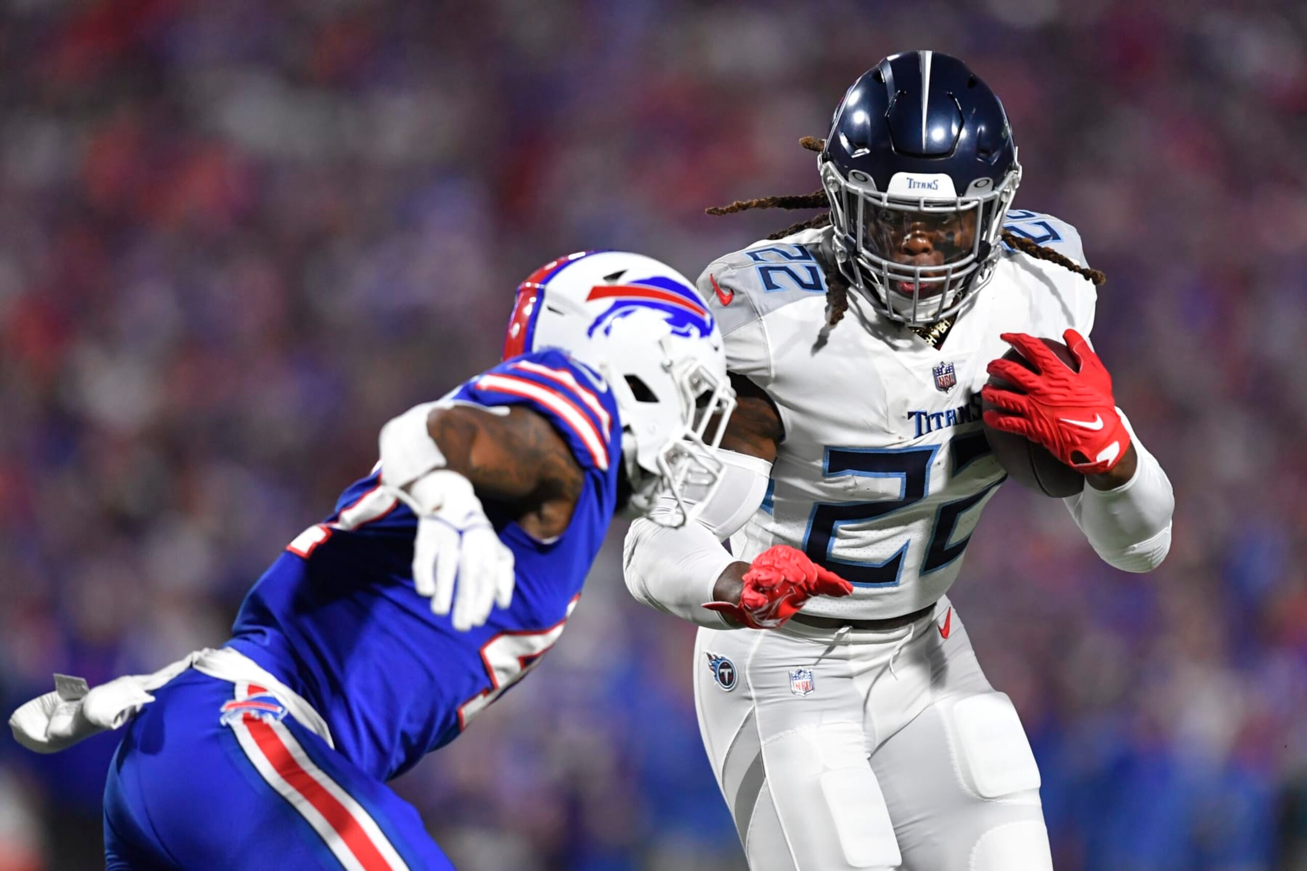 Tennessee Titans' Derrick Henry, right, rushes past Buffalo Bills' Christian Benford during the first half of an NFL football game Monday, Sept. 19, 2022, in Orchard Park, N.Y. (AP Photo/Adrian Kraus)