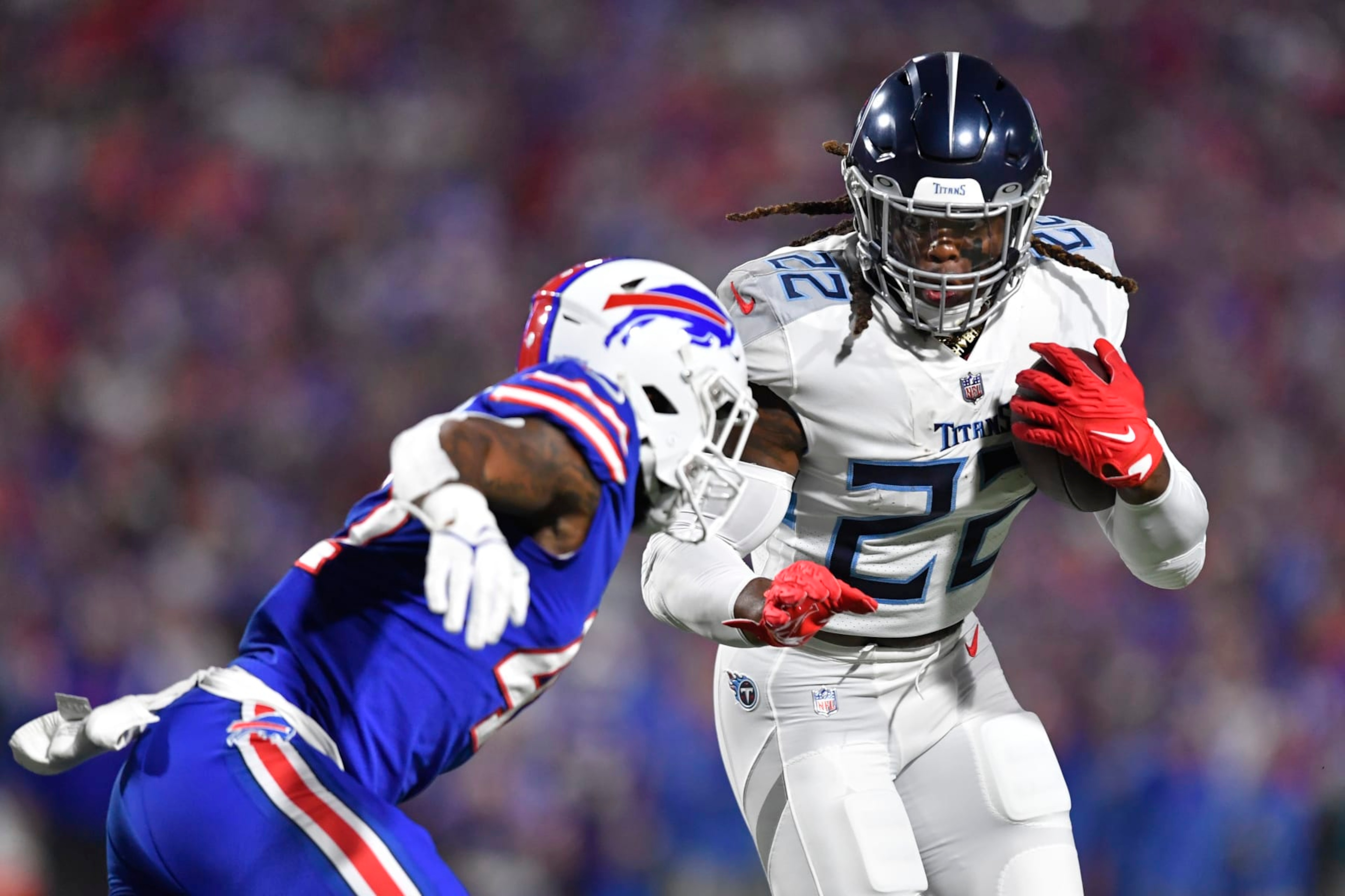 Tennessee Titans' Derrick Henry, right, rushes past Buffalo Bills' Christian Benford during the first half of an NFL football game Monday, Sept. 19, 2022, in Orchard Park, N.Y. (AP Photo/Adrian Kraus)