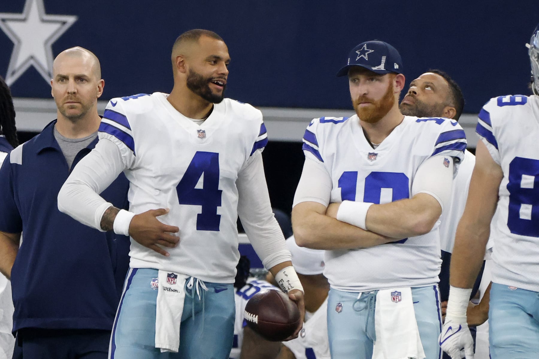 Dallas Cowboys quarterback Dak Prescott (4) talks to quarterback Cooper Rush (10) on the sideline during an NFL football game against the New York Giants in Arlington, Texas, Sunday, Oct. 10, 2021. (AP Photo/Michael Ainsworth)