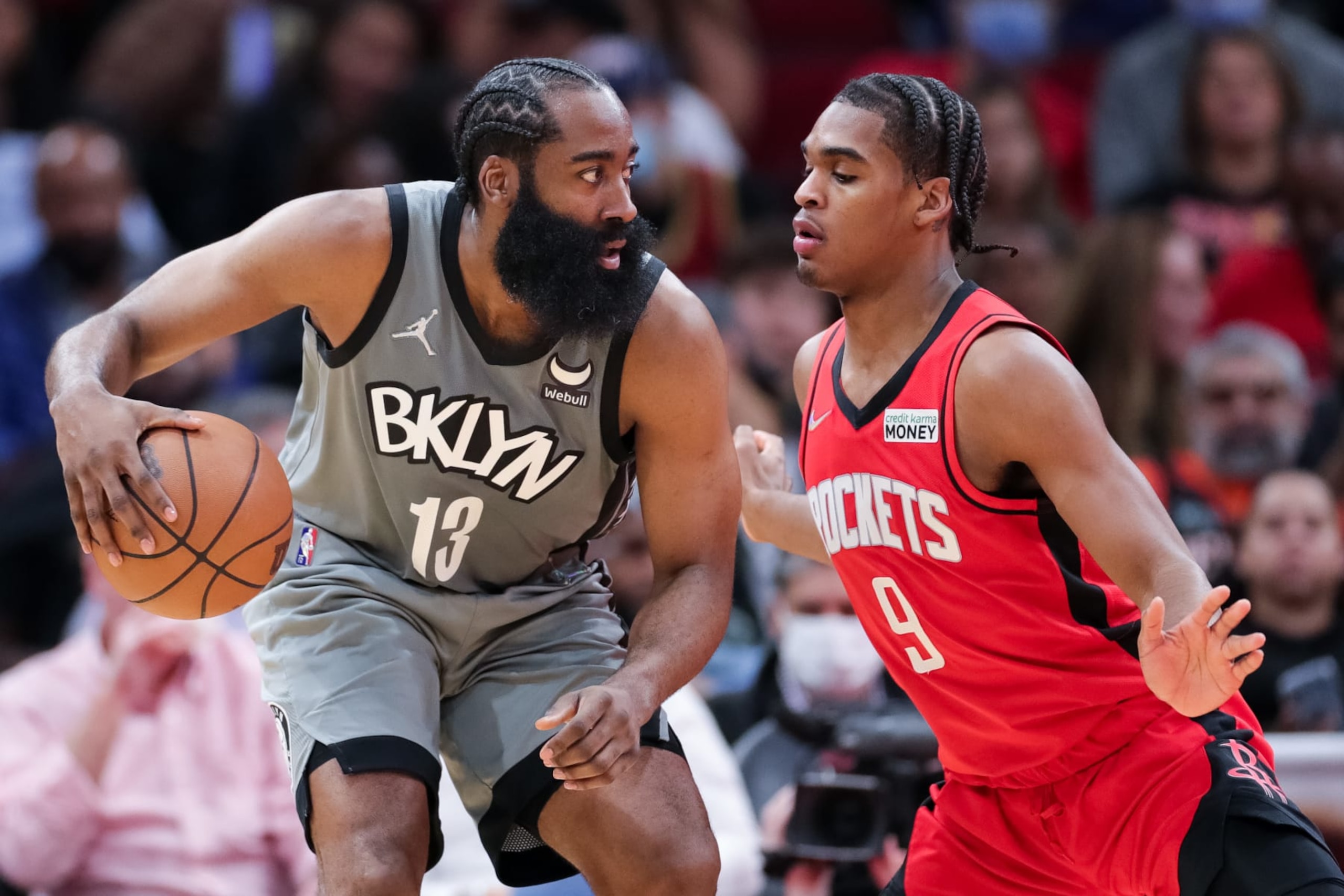 HOUSTON, TEXAS - DECEMBER 08: James Harden #13 of the Brooklyn Nets controls the ball ahead of Josh Christopher #9 of the Houston Rockets during the first half at Toyota Center on December 08, 2021 in Houston, Texas. NOTE TO USER: User expressly acknowledges and agrees that, by downloading and or using this photograph, User is consenting to the terms and conditions of the Getty Images License Agreement. (Photo by Carmen Mandato/Getty Images)