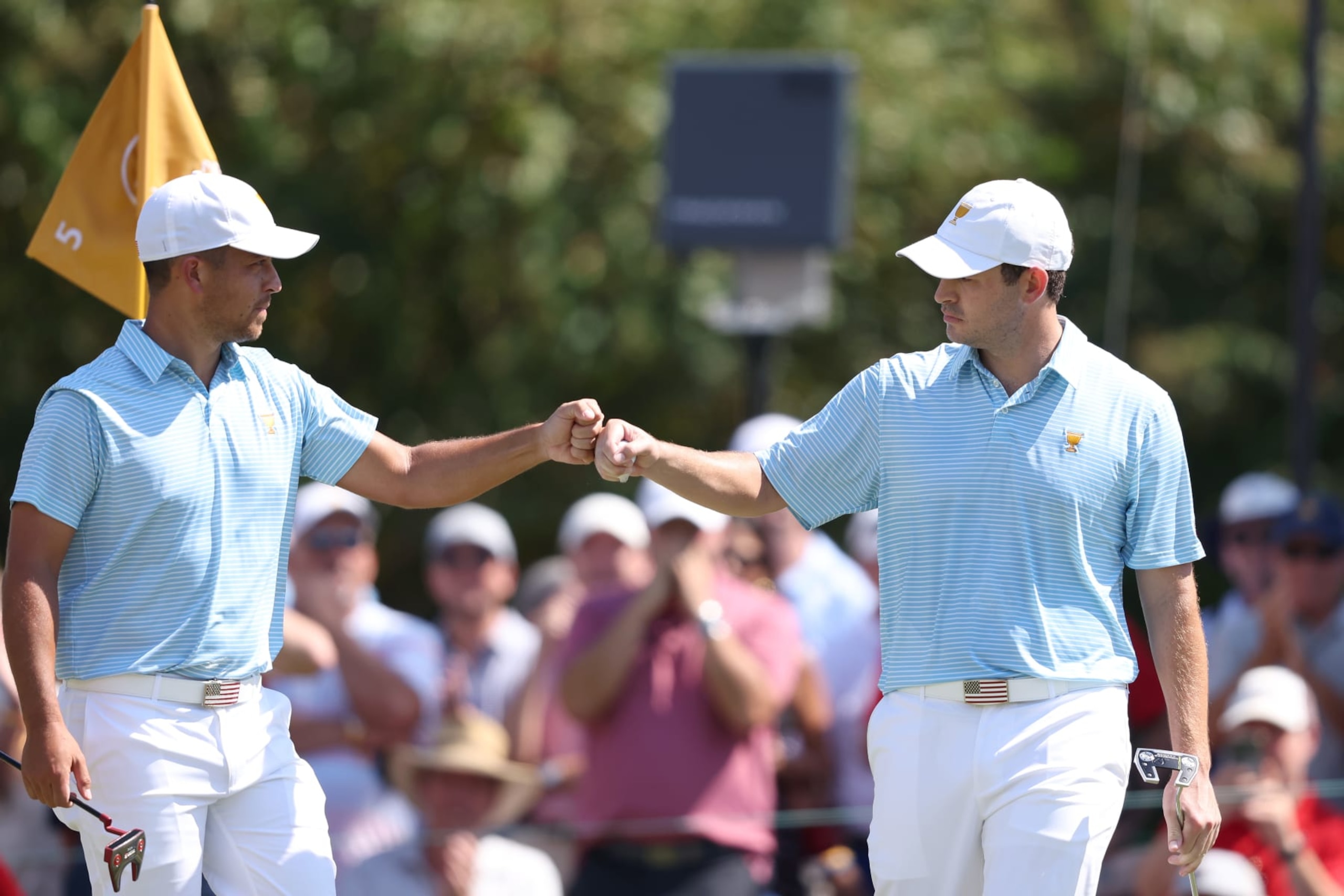 CHARLOTTE, NORTH CAROLINA - SEPTEMBER 22: (L-R) Xander Schauffele of the United States Team and Patrick Cantlay of the United States Team fist bump on the fifth green during the Thursday foursome matches on day one of the 2022 Presidents Cup at Quail Hollow Country Club on September 22, 2022 in Charlotte, North Carolina. (Photo by Warren Little/Getty Images) CHARLOTTE, NORTH CAROLINA - SEPTEMBER 22: (L-R) Xander Schauffele of the United States Team and Patrick Cantlay of the United States Team fist bump on the fifth green during the Thursday foursome matches on day one of the 2022 Presidents Cup at Quail Hollow Country Club on September 22, 2022 in Charlotte, North Carolina. (Photo by Warren Little/Getty Images)