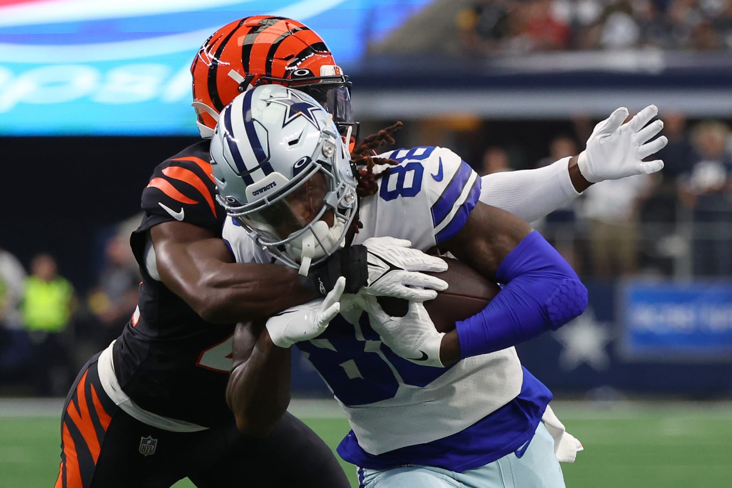 ARLINGTON, TEXAS - SEPTEMBER 18: CeeDee Lamb #88 of the Dallas Cowboys runs with the ball and is tackled by Chidobe Awuzie #22 of the Cincinnati Bengals during the first half at AT&T Stadium on September 18, 2022 in Arlington, Texas. (Photo by Richard Rodriguez/Getty Images)